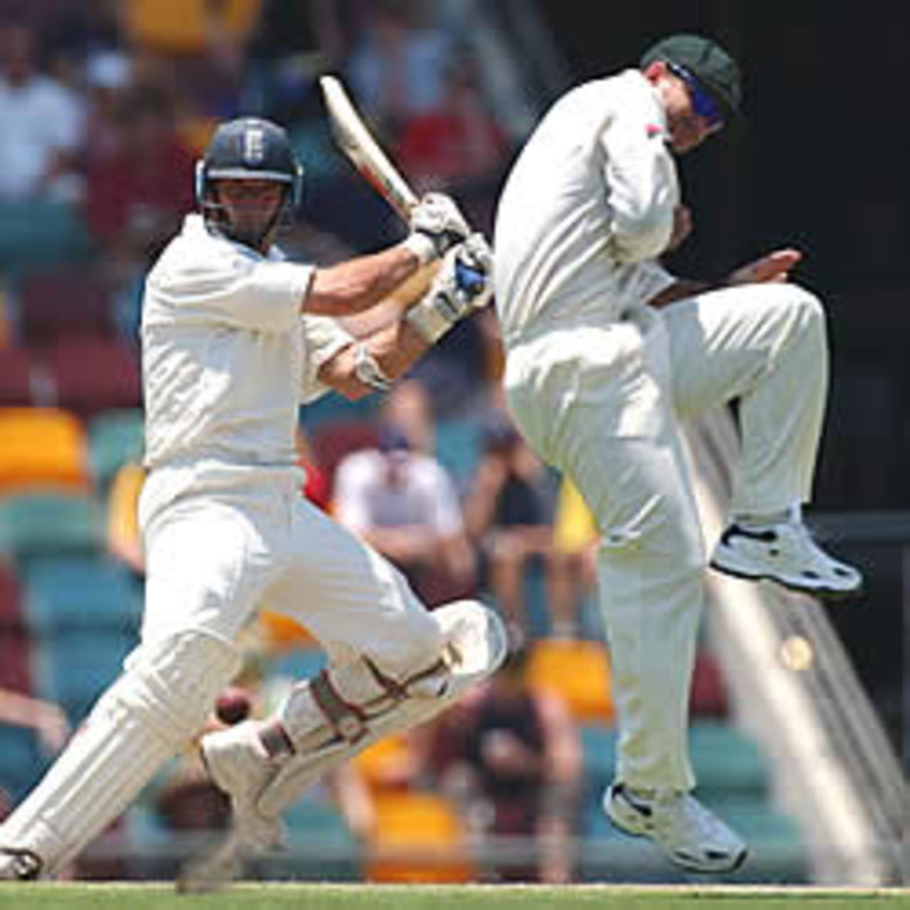 BRISBANE - NOVEMBER 9: England captain Nasser Hussain hits the ball past Ricking Ponting of Australia during day three of the first Ashes Test between Australia and England at the Gabba in Brisbane, Australia on November 9, 2002.