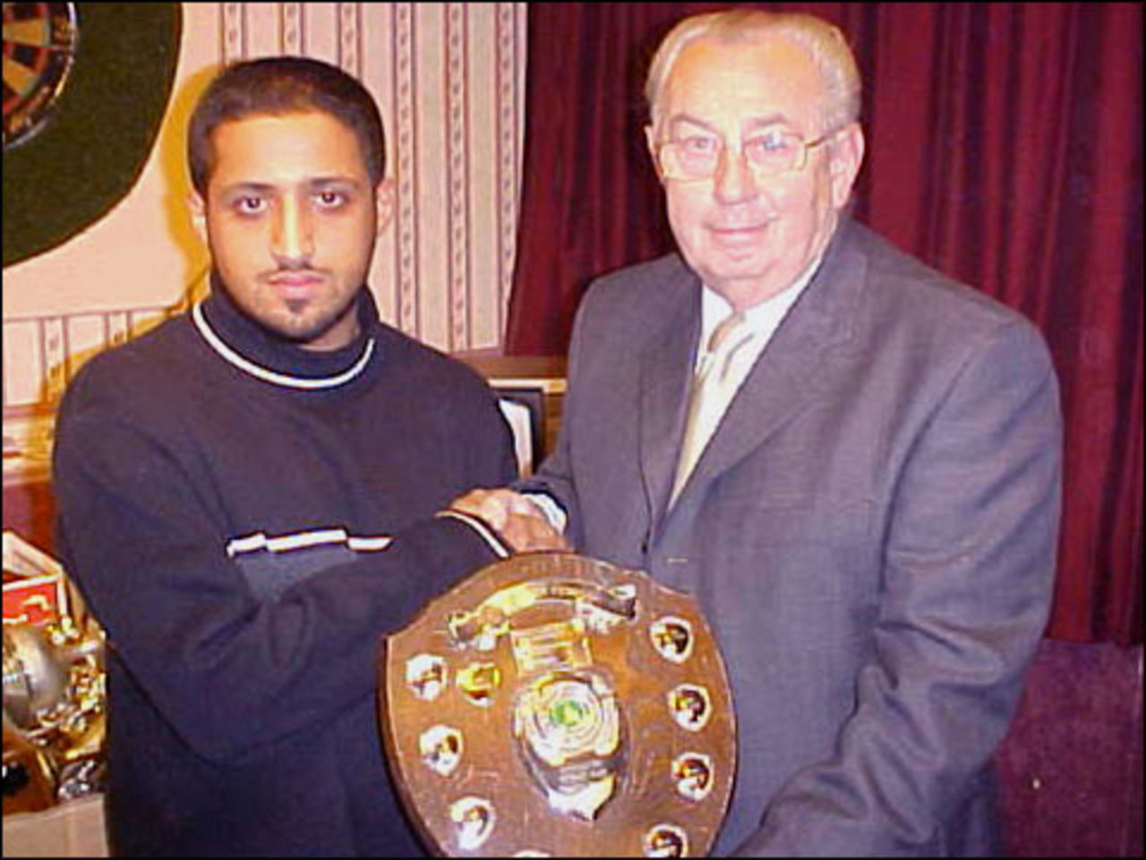 Mohsin Ahmed receiving a trophy from Accrington Cricket Club Chairman Peter Barratt