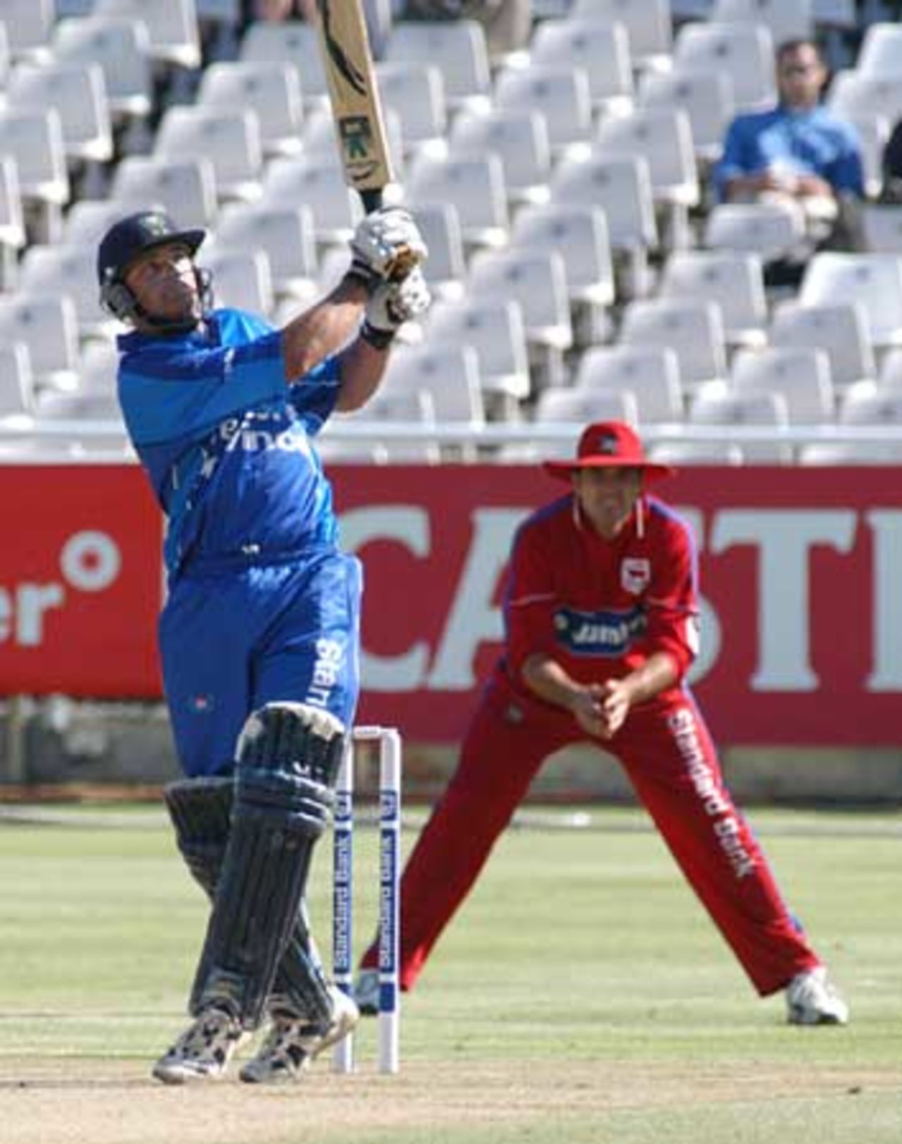 Lloyd Ferreira hits out against EP Jumbo's at Newlands with Justin Kemp looking on