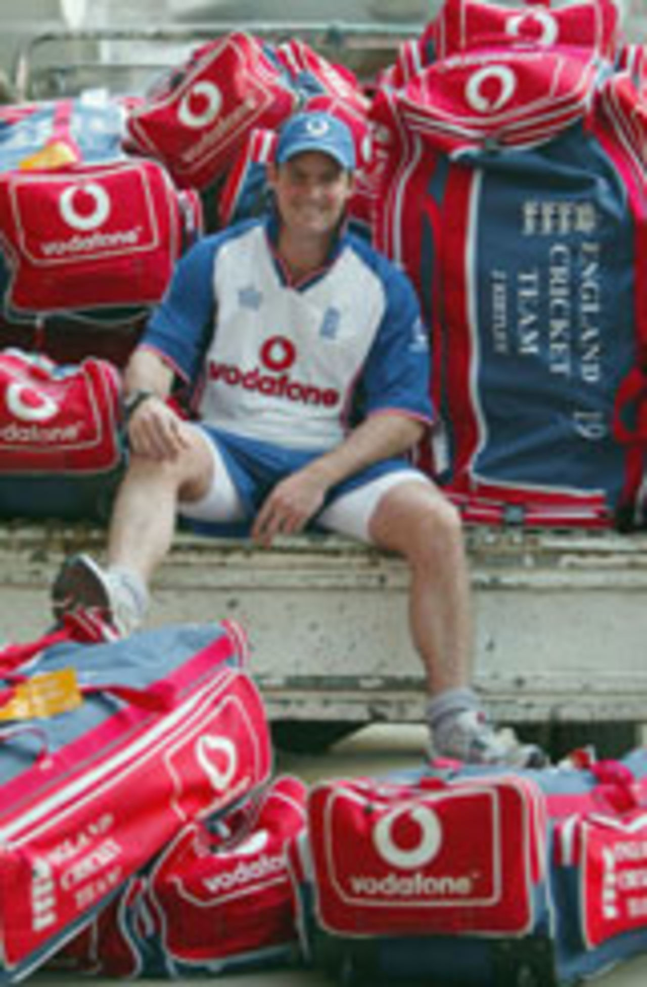 Andy Strauss surrounded by England kit bags, Chittagong, November 6, 2003