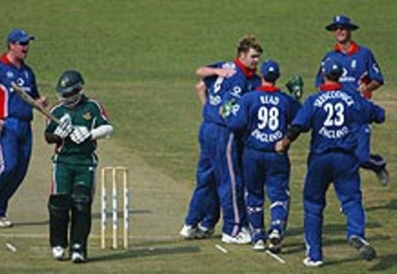 England celebrate the fall of the first wicket in Dhaka