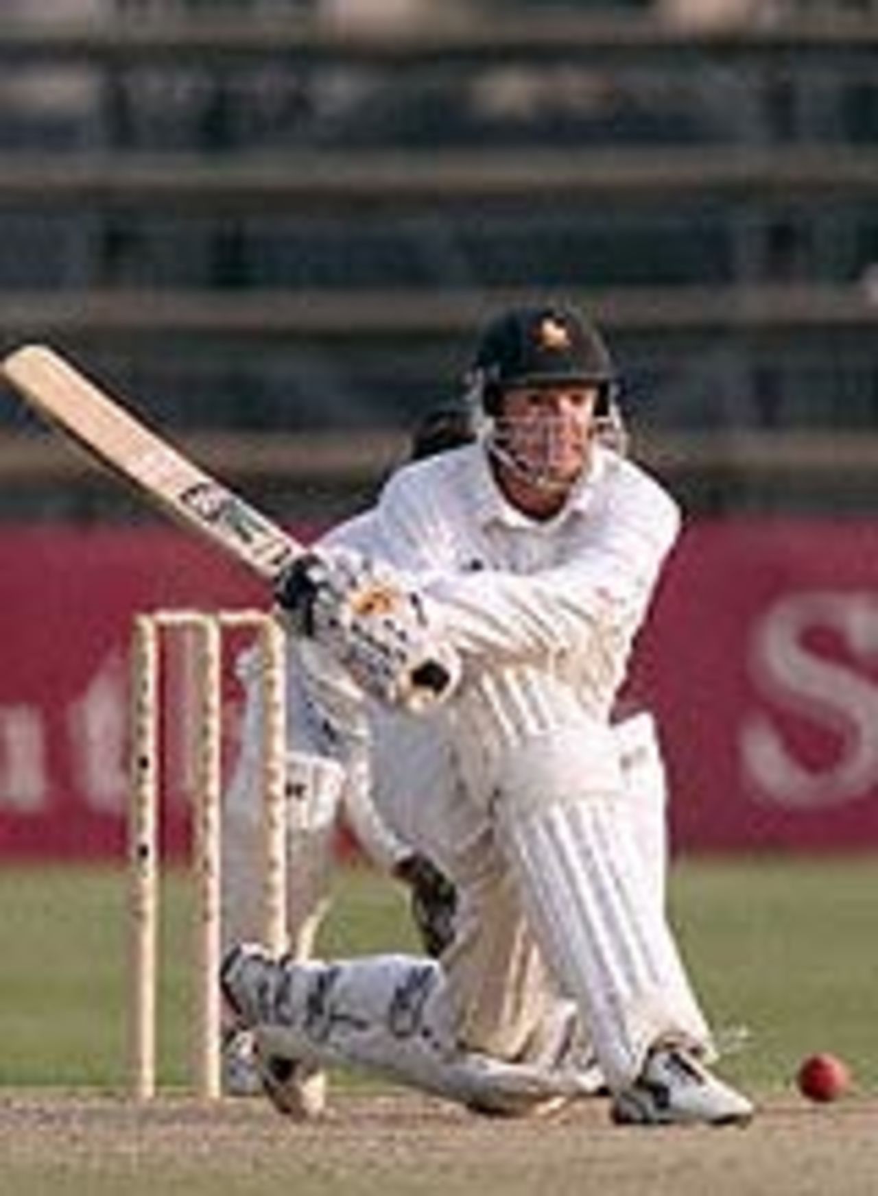 Andy Flower prepares a reverse sweep watched by Shaun Pollock, Ist Test South Africa v Zimbabwe, 7-11 September 2001, at Harare.