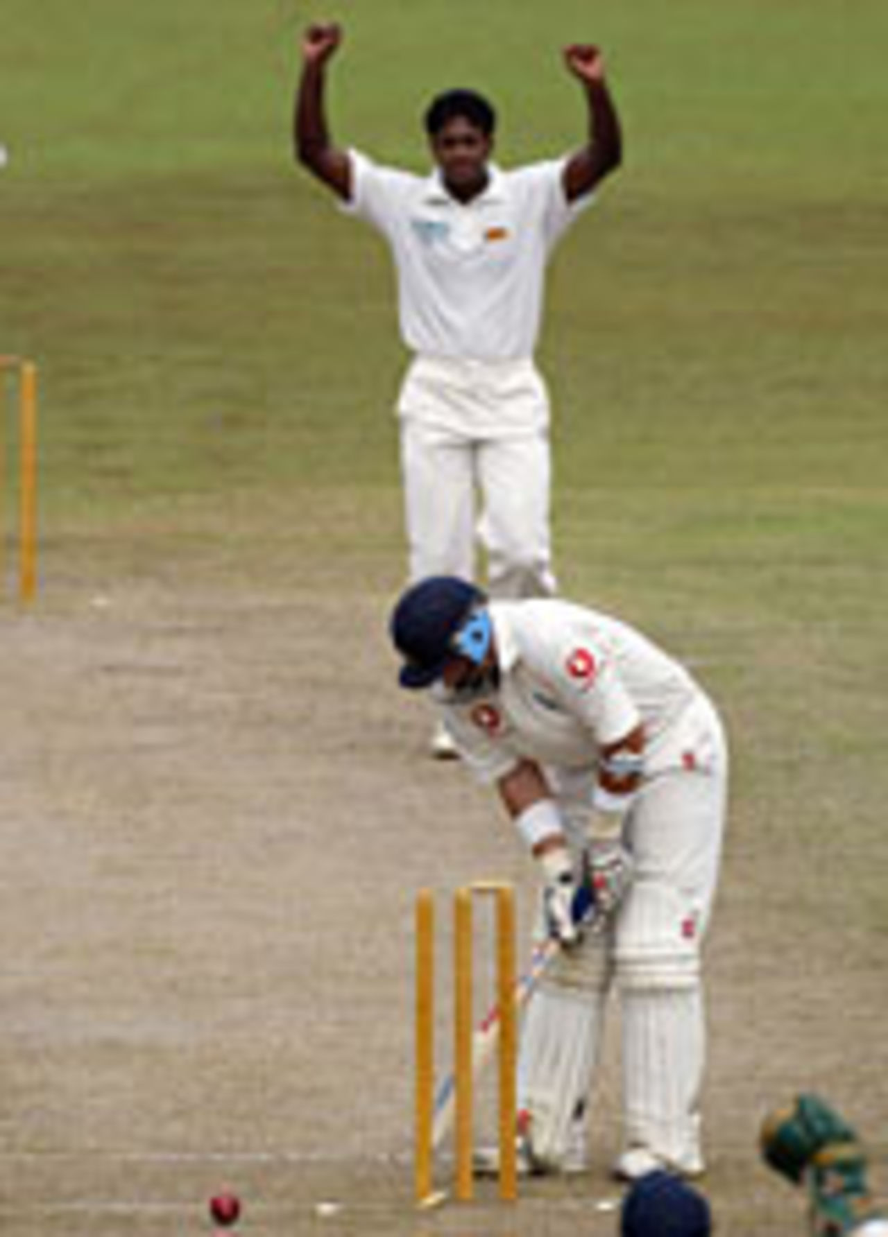 Nasser Hussain watches a ball from Dilhara Fernando trickle into his stumps, Sri Lanka Cricket President's XI v England, Colombo, November 27, 2003