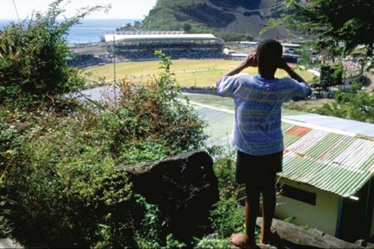 A young West Indian fan looks down on the action