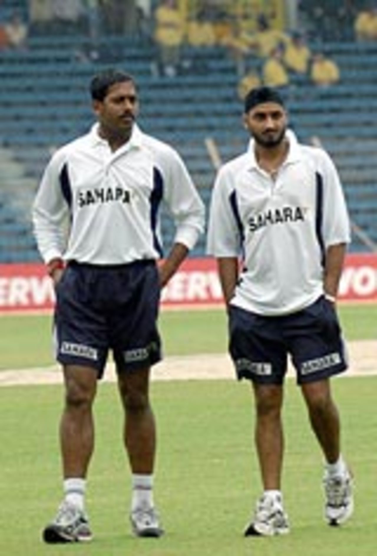 Harbhajan Singh and SS Paul trudge round a soggy ground, India v Australia, 1st Test, Mumbai, November 3, 2004