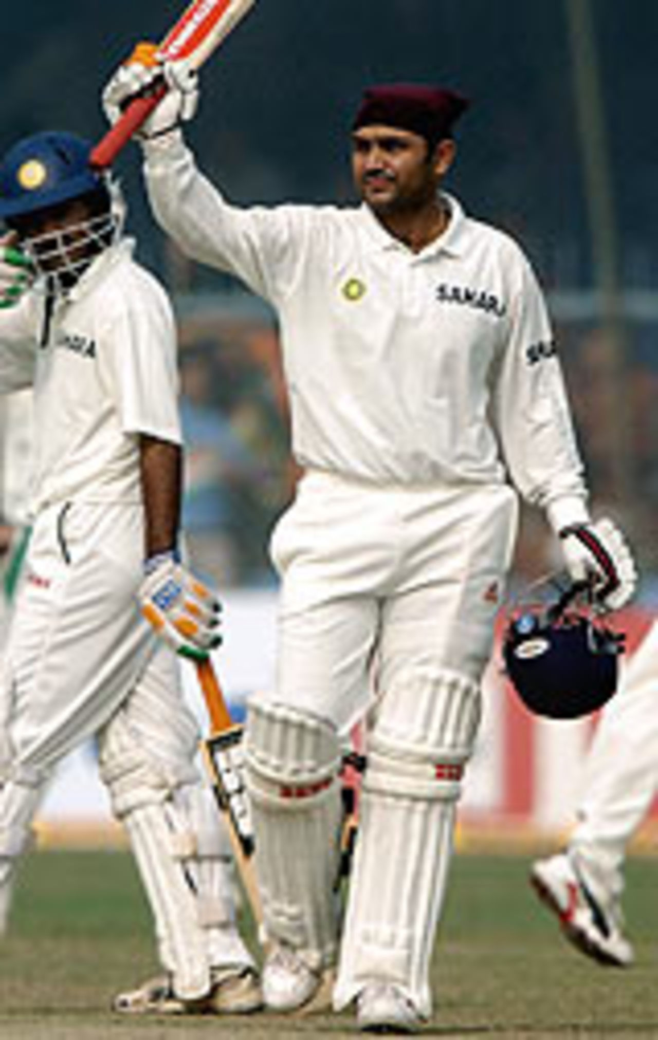 Virender Sehwag raises his bat after his century, India v South Africa, 1st Test, Kanpur, 4th day, November 23, 2004