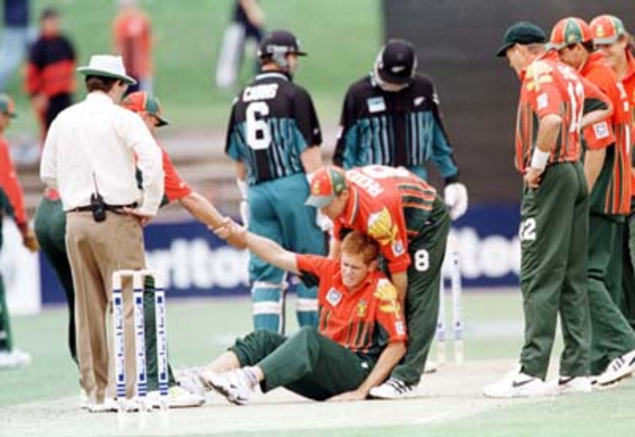 Teammates help Shaun Pollock to his feet after he was hit in the shin by a drive from Fleming ....South Africa v New Zealand ODI, at the Adelaide Oval, Saturday December 6th 1997.