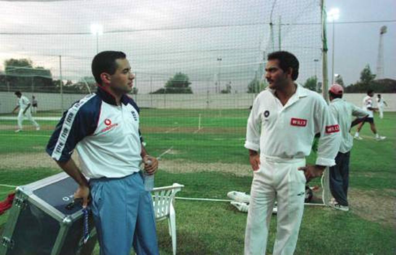 Adam Hollioake chats with Mohammed Azharuddin during nets in Sharjah