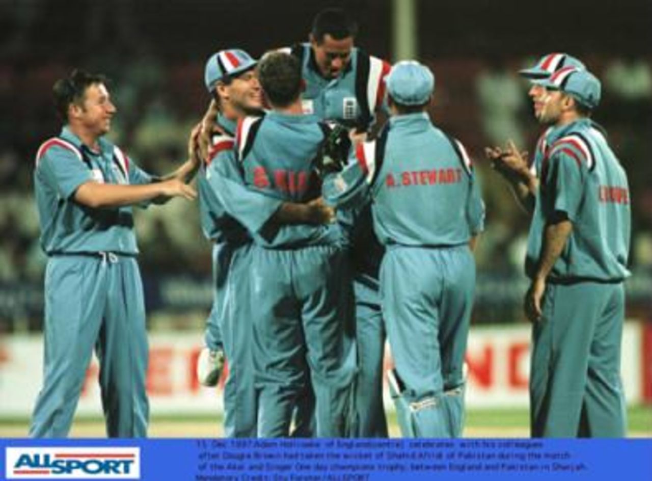 Adam Hollioake and his England colleagues celebrate Dougie Brown's taking the wicket of Shahid Afridi in England's match with Pakistan during the Champions Trophy in Sharjah.