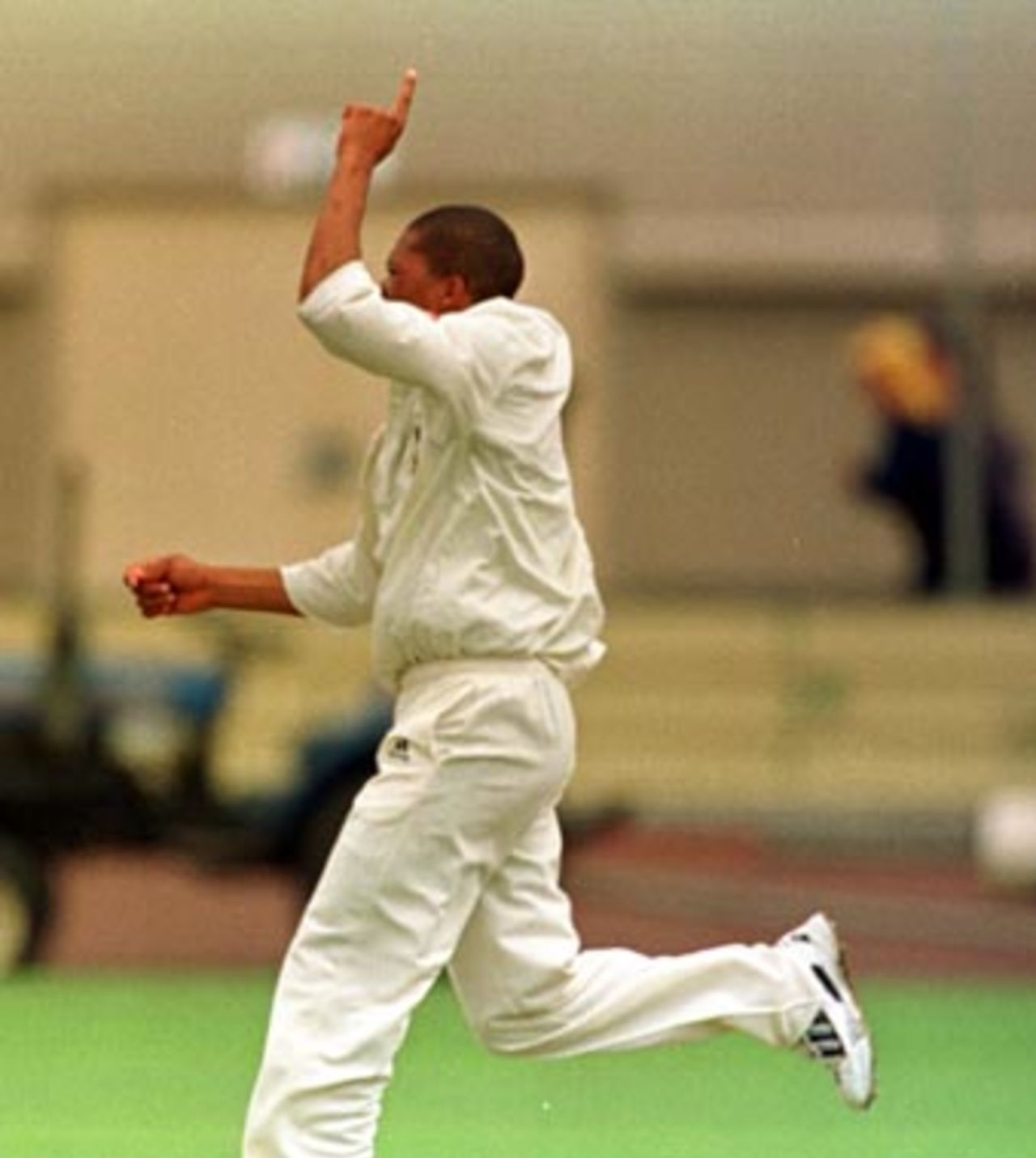 So good..finally...Makhaya Ntini runs down the wicket after snaring his first wicket of the tour, that of Jamie Cox, caught in slips ..... South Africans v Tasmania, Day 4, December 16th 1997.