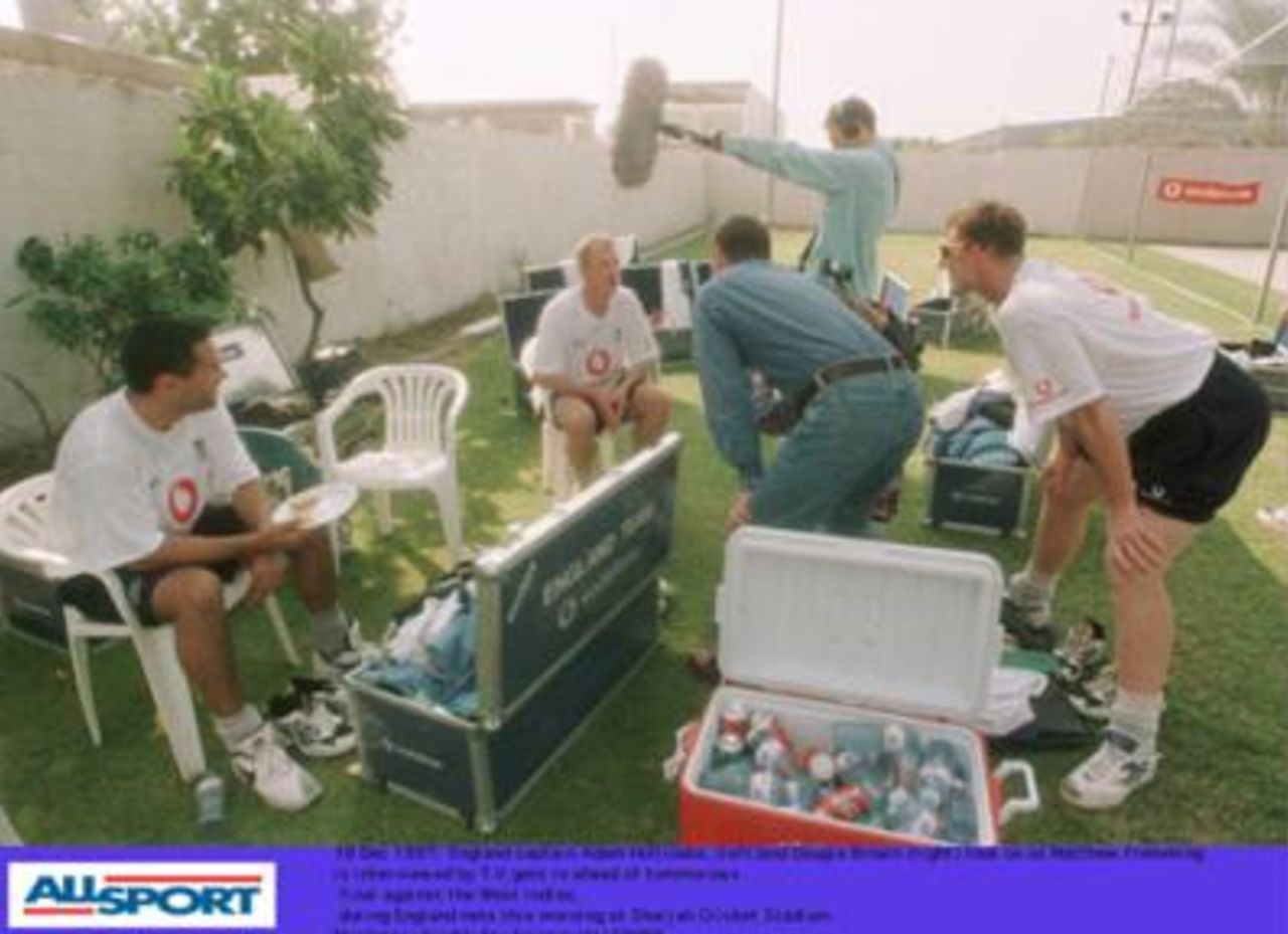 Matthew Fleming is interviewed by a TV crew on Dec 18 1997, the day before the final of the Champions Trophy in Sharjah between England and Pakistan. Adam Hollioake and Dougie Brown look on.