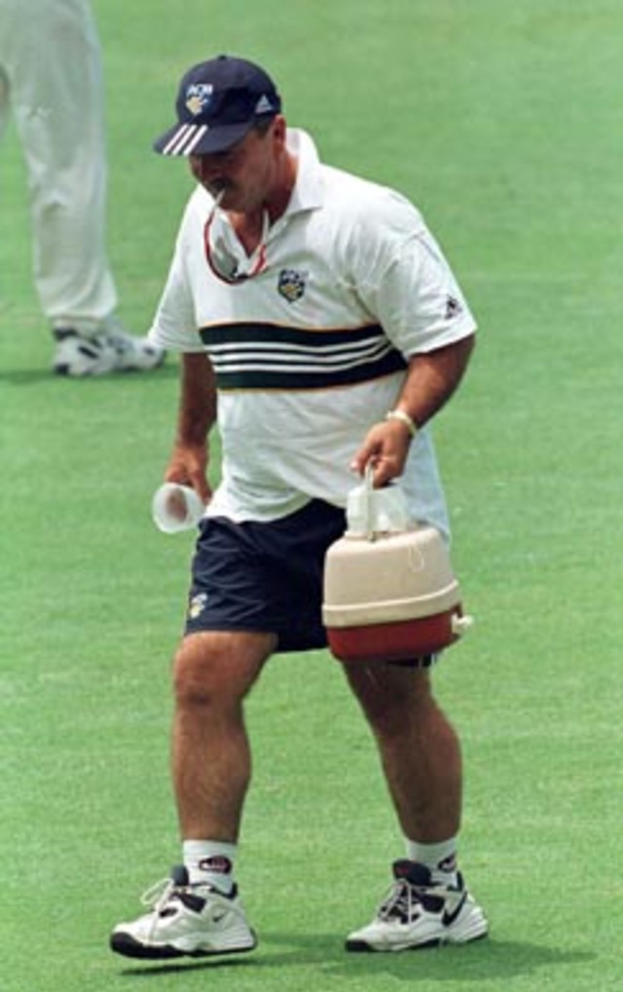 Rod Marsh (Australia 'A' coach ) carries the drinks after Adam Dale was too ill to take the field during the 2nd day of the Australia 'A' v South Africa 4 day match at the Gabba in Brisbane. December 20th 1997.