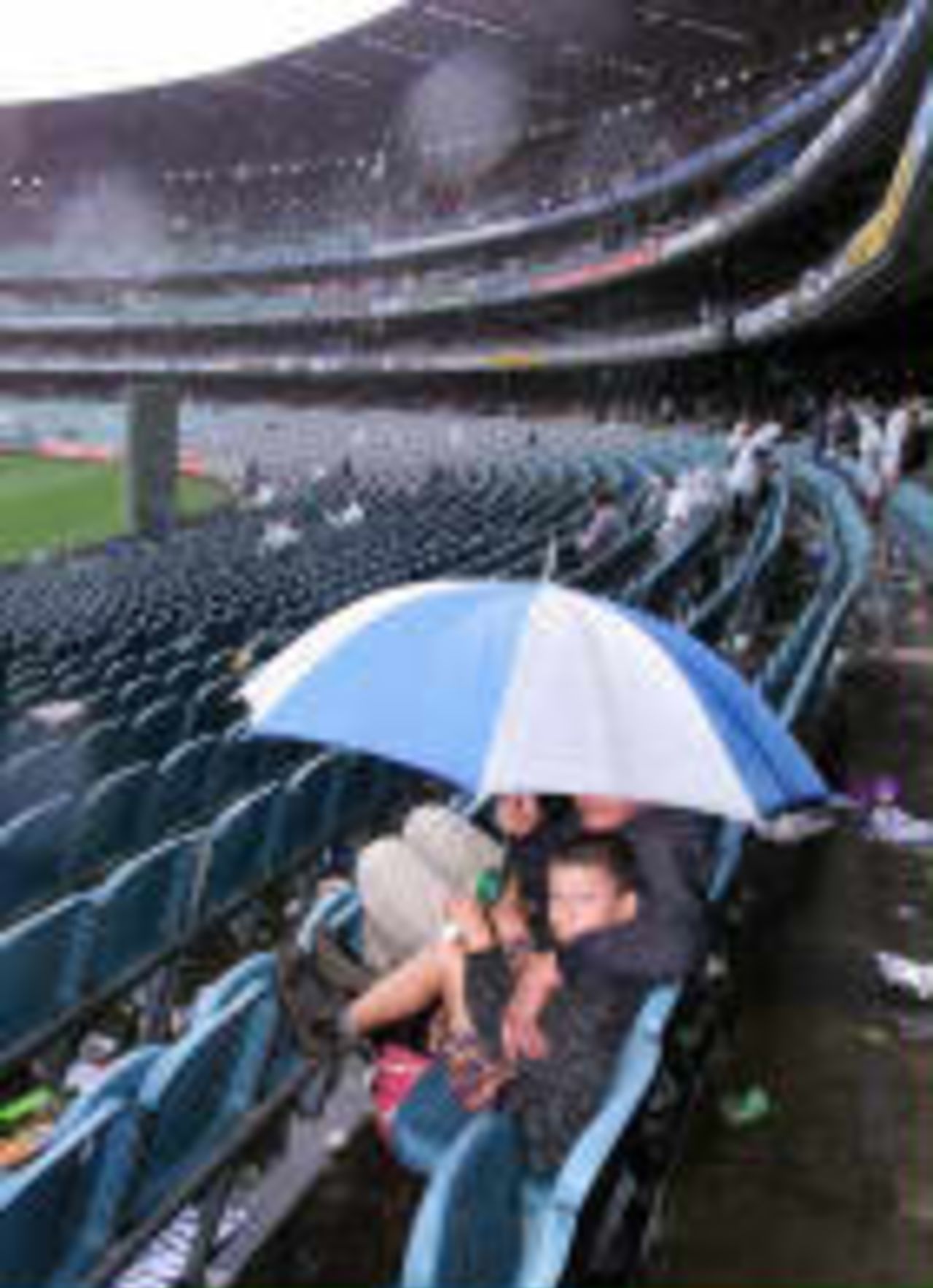 Spectators sheltering from the rain that washed out the first day The Ashes, 1998/99, 4th Test Australia v England Melbourne Cricket Ground 26 December 1998