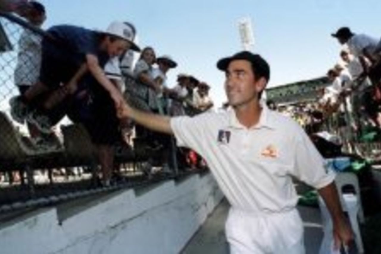 28 Nov 1999: Australia's Justin Langer, named Player of the Series is congratulated by a young fan as he leaves the WACA Ground, following Australia's 3 - 0 series win over Pakistan on day three of the third test played between Australia and Pakistan at the WACA Ground in Perth, Western Australia, Australia.