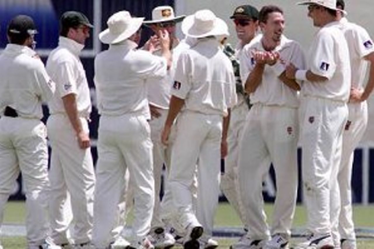 14 Dec 1999: Damien Fleming of Australia jokes with team mates after he and Justin Langer collided before Langer completed a catch to dissmiss Mannava Prasad of India off Fleming's bowling, on day five of the first test between Australia and India, at the Adelaide Oval, Adelaide, Australia. Australia won by 285 runs.