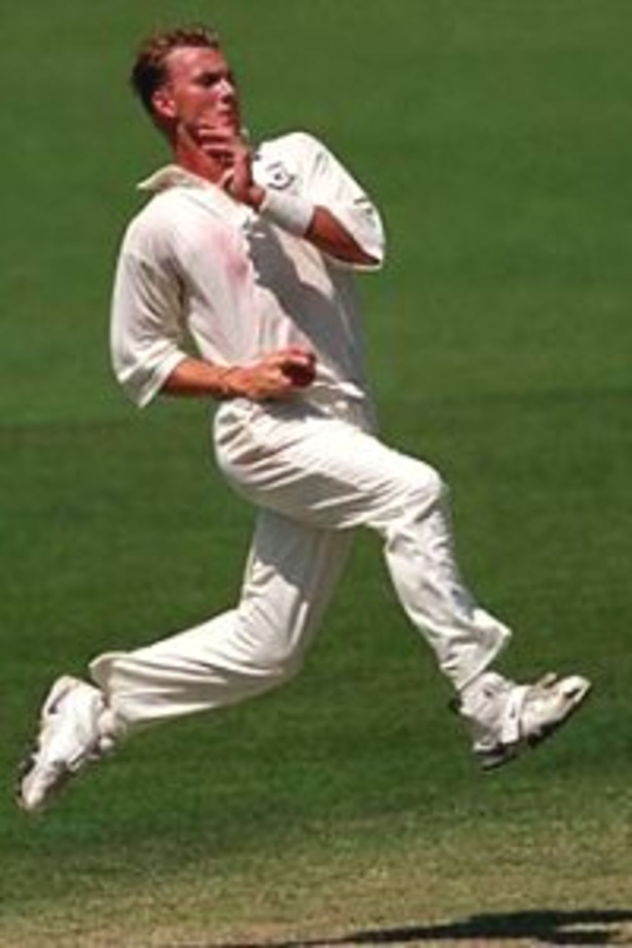 7 Dec 1999: Brett Lee, bowler for the Prime Ministers X1 sends down a delivery in the game against India played at Manuka Oval, Canberra, Australia.