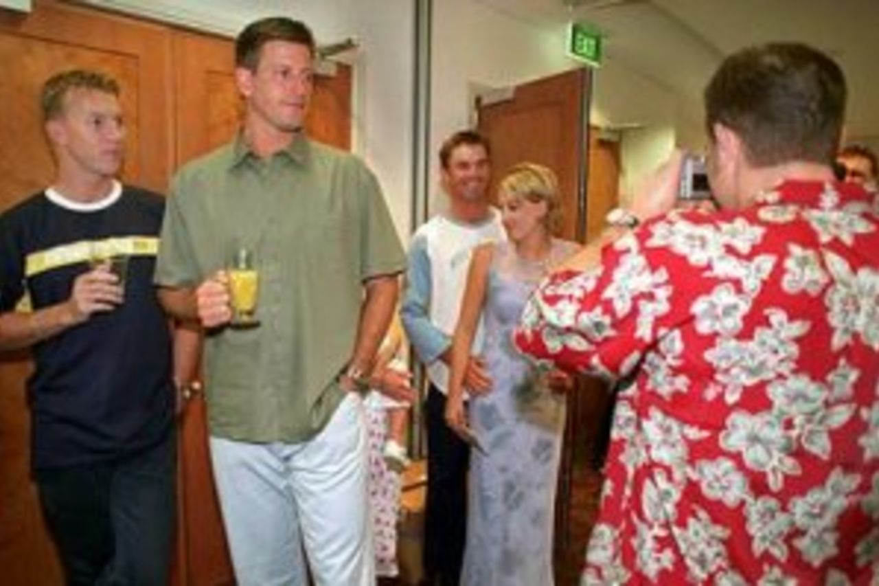 25 Dec 1999: Australian cricket team members, Brett Lee (left) and Michael Kasprowicz watch Michael Slater take a picture of Greg Blewett and friend during the Australian team's Christmas lunch at their team hotel this morning. Tommorrow Australia play India at the Melbourne Cricket Ground, Melbourne, Australia, in the Boxing Day Test Match.