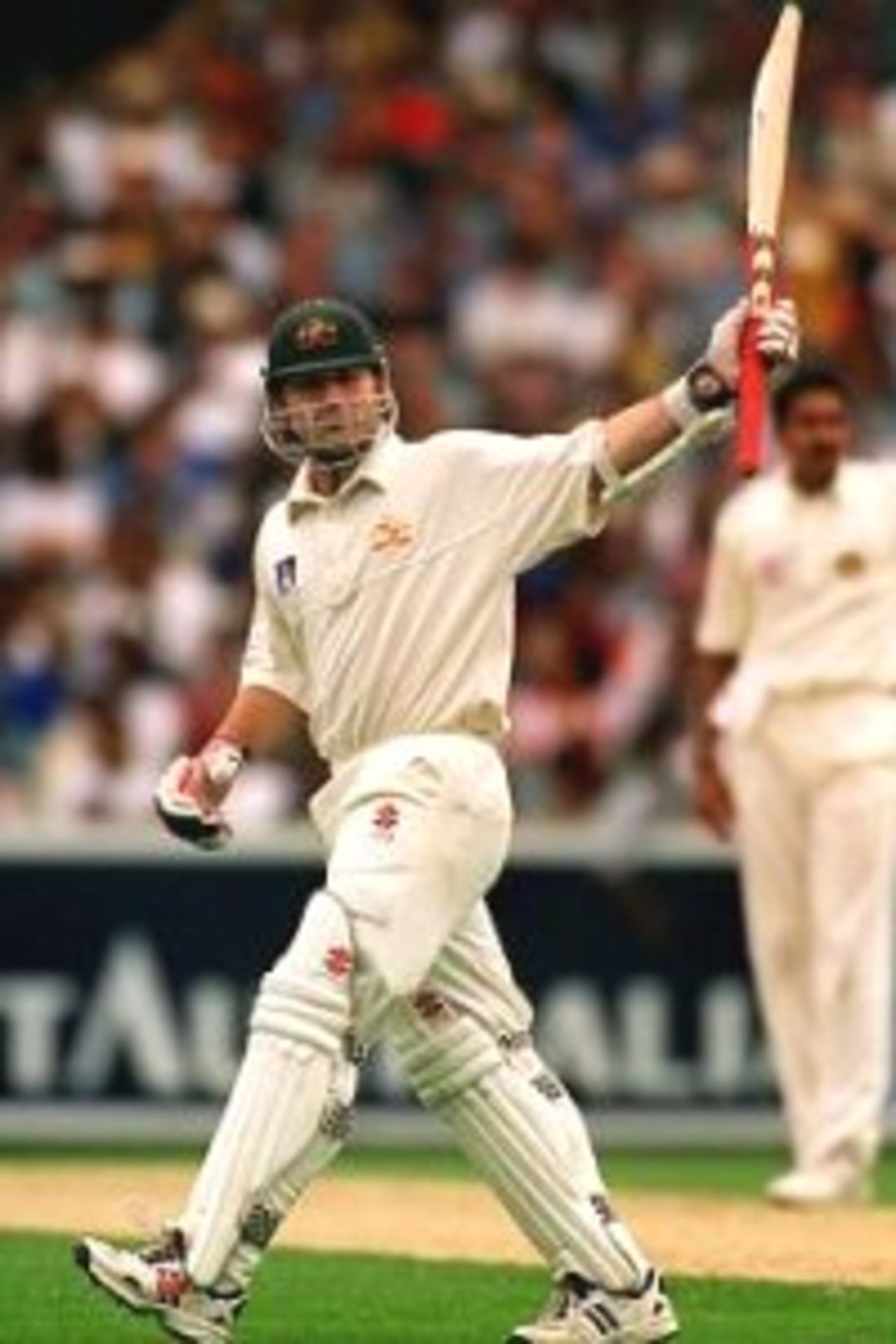 Dec 1999: Australian cricket team batsman Michael Slater salutes the crowd after reaching fifty runs during the Boxing Day Cricket Test match between Australia and India at the Melbourne Cricket Ground, Melbourne, Australia. Bad light stopped play with Australia on 3 for 138.