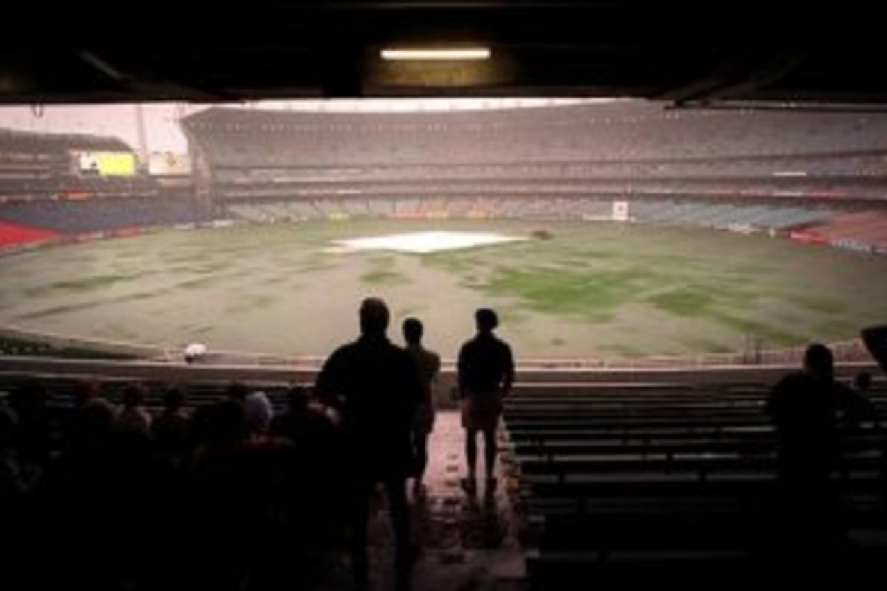 27 Dec 1999: The crowd watch a sodden grond at the Melbourne Cricket Ground amid a severe rain delay on day two of the second test match between Australia and India, played at the Melbourne Cricket Ground, Melbourne, Australia. The day's play was abandoned due to rain.