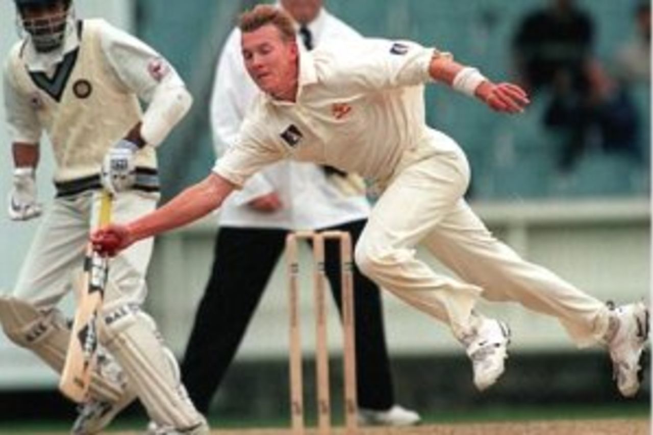 28 Dec 1999: Australian pace bowler Brett Lee fields off his own bowling, on day three of the second test match between Australia and India, played at the Melbourne Cricket Ground, Melbourne, Australia.
