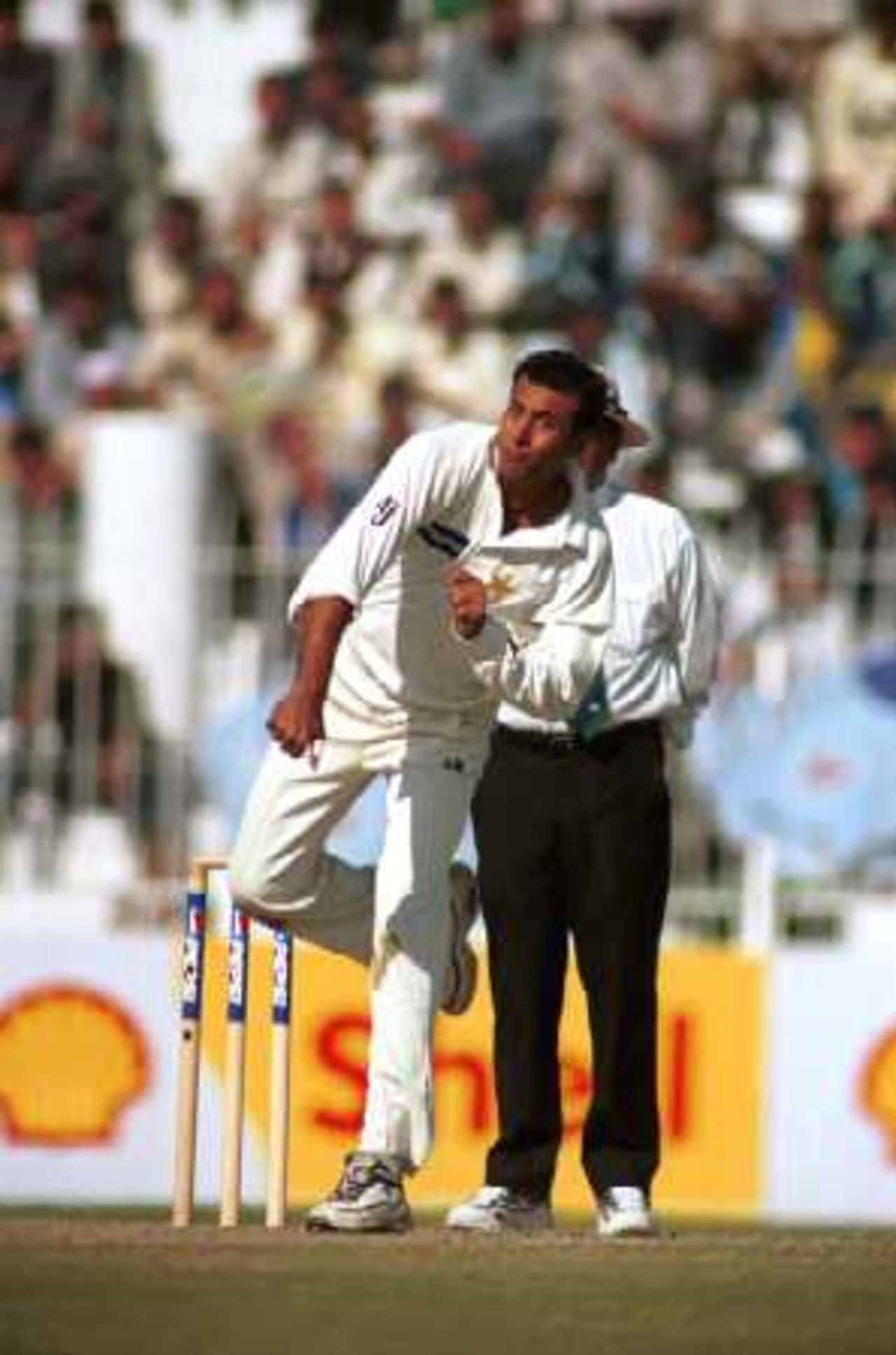 Arshad Khan in his follow through, Day 3, 2nd Test Match, Pakistan v England at Faisalabad, 29 Nov-3 Dec 2000.