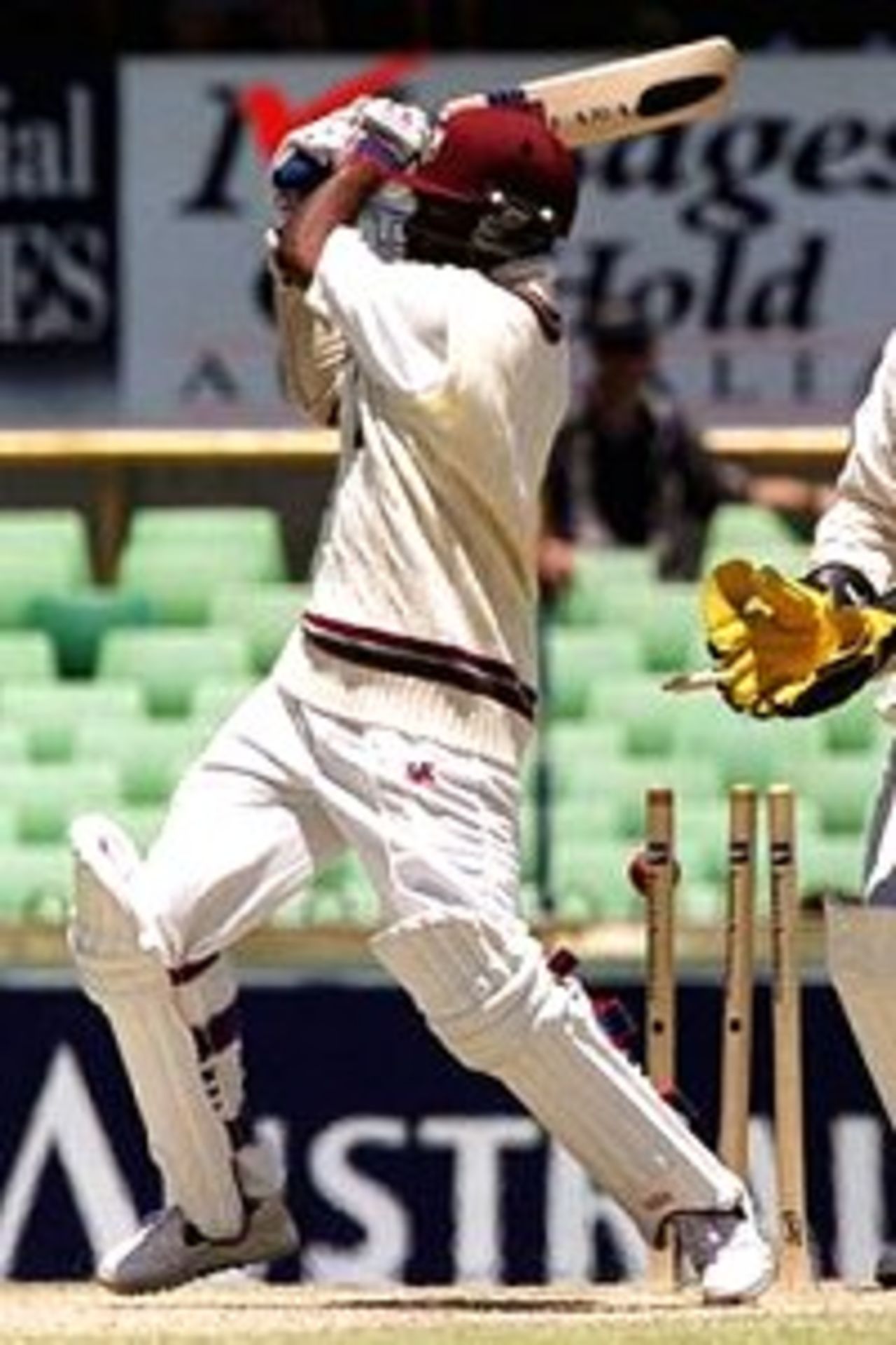 Brian Lara of West Indies is bowled by Stuart MacGill of Australia for 17 as wicketkeeper Adam Gilchrist looks on during the third days play of the Second Test match between Australia and West Indies at the WACA Cricket Ground, Perth, Australia.