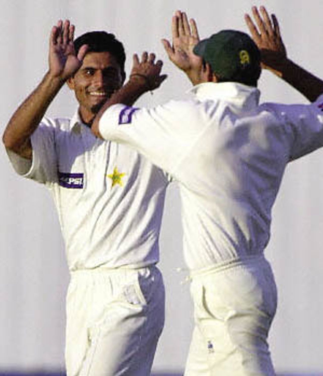 Abdur Razzaq and Shahid Afridi celebrate the fall of an English wicket, England in Pakistan, 2000/01, 2nd Test, Pakistan v England, Iqbal Stadium, Faisalabad, 29Nov-03Dec 2000 (Day 3).