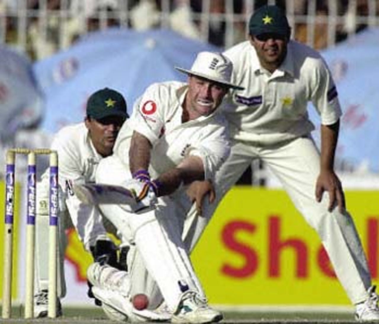 Graham Thorpe sweeps the spinners as Moin Khan and Inzamam ul-Haq watch, England in Pakistan, 2000/01, 2nd Test, Pakistan v England, Iqbal Stadium, Faisalabad, 29Nov-03Dec 2000 (Day 3).