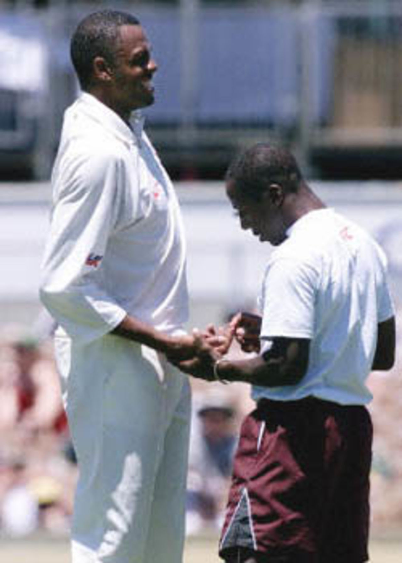 Walsh feels the pain as team trainer checks his hand, The Frank Worrell Trophy, 2000/01, 2nd Test, Australia v West Indies, W.A.C.A. Ground, Perth, 01-05 December 2000 (Day 2).