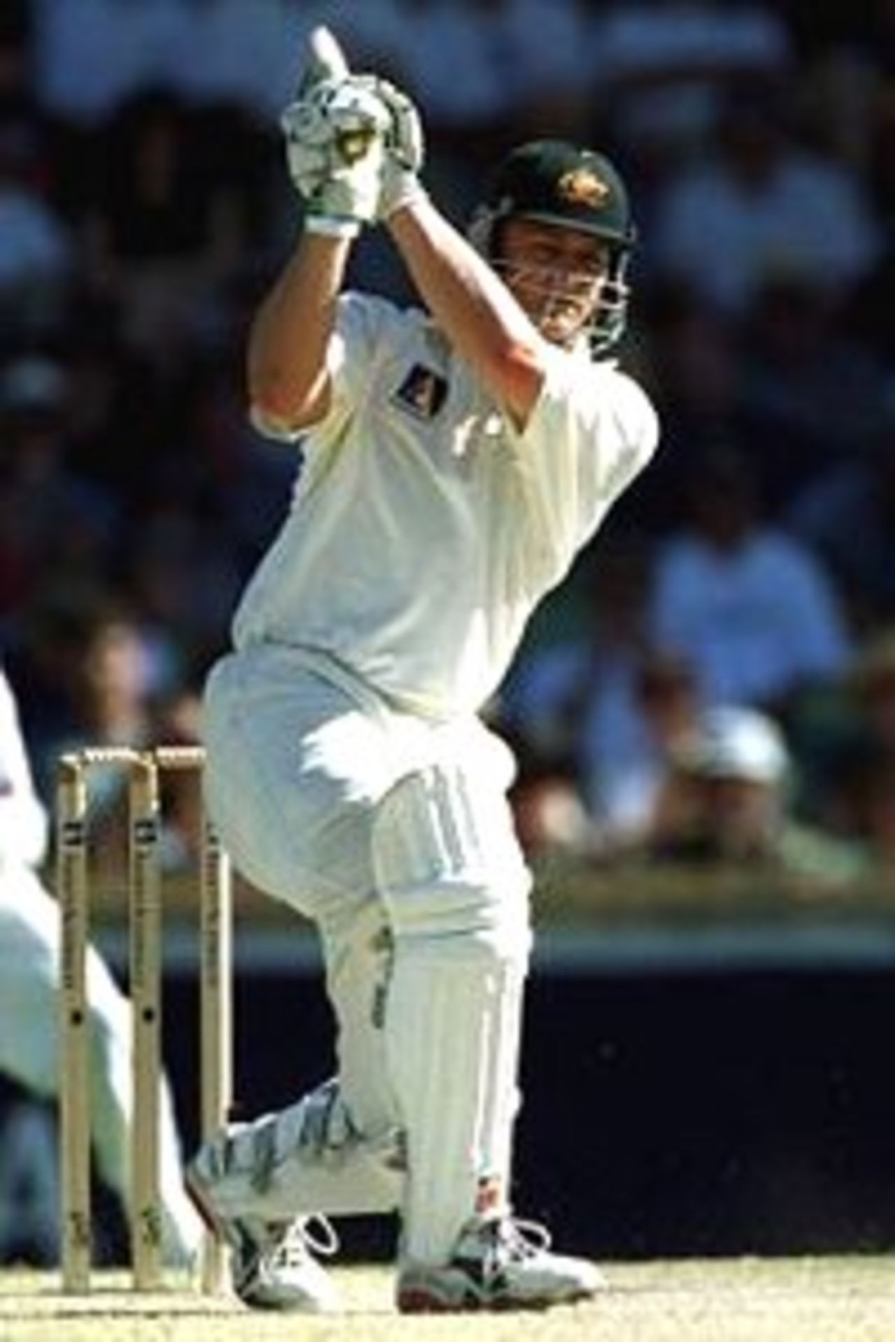 Adam Gilchrist of Australia drives during his innings of 50 during the second days play of the Second Test match between Australia a West Indies at the WACA Cricket Ground, Perth, Australia.