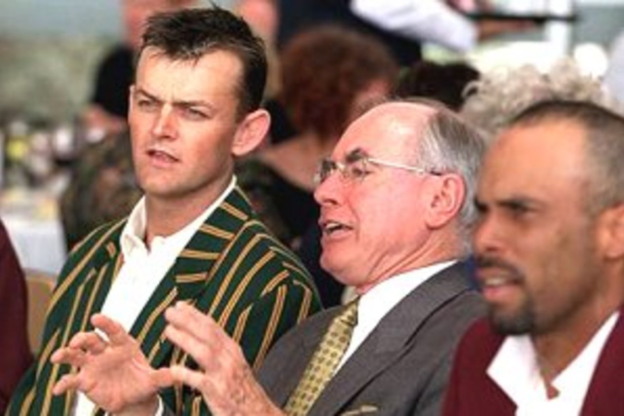 Left to right; Prime Ministers X1 captain Adam Gilchrist, Australian Prime Minister John Howard and West Indies captain Jimmy Adams look on during lunch during the one day cricket game between the Prime Ministers X1 and the West Indies at the Manuka Oval, Canberra, Australia.