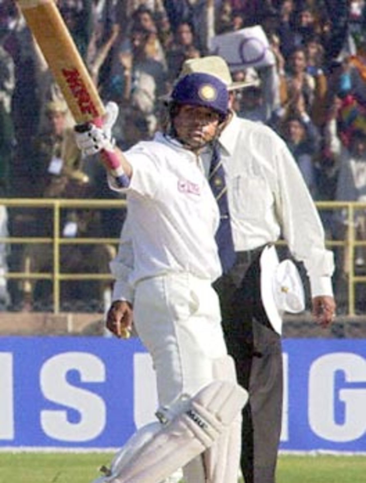 Indian ace batsman Sachin Tendulkar raises his bat to acknowledge the cheering crowd after scoring a century during the third one-day international cricket match against Zimbabwe at Jodhpur, 08 December 2000. Tendulkar hit 146 off 153 balls as India piled up 283-8 from 50 overs in the one-day competition against Zimbabwe. The right-hander hit 15 boundaries and two sixes in his 27th one-day hundred, almost the most by any batsman in the shorter version of the game.