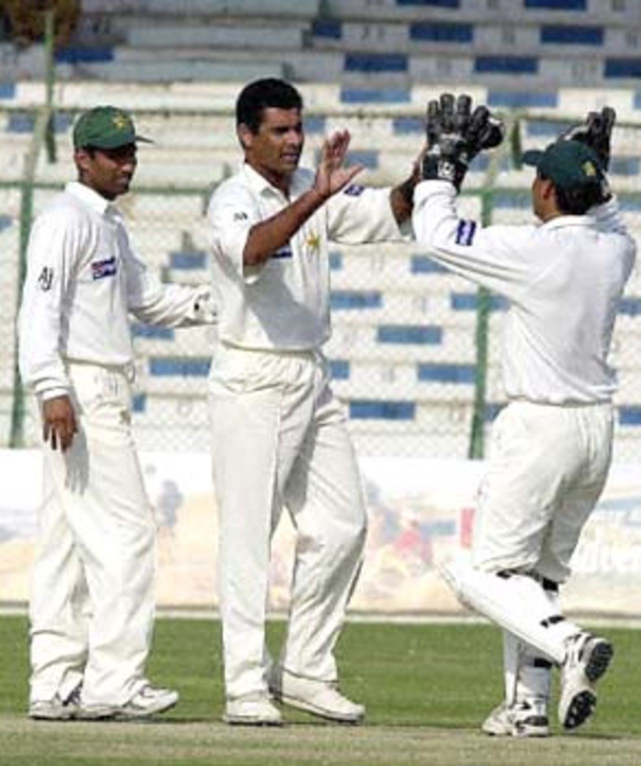 Pakistani pacer Waqar Younis (C) celebrates England batsman Graham Thorpe's fall with captain Moin Khan (R) and teammate Yousuf Youhanna (L) on day three of the third and final Tests at National stadium Karachi, 09December, 2000. Younis took 2-41 as England reached 199-3 at tea in reply to Pakistan's 405 in their first innings