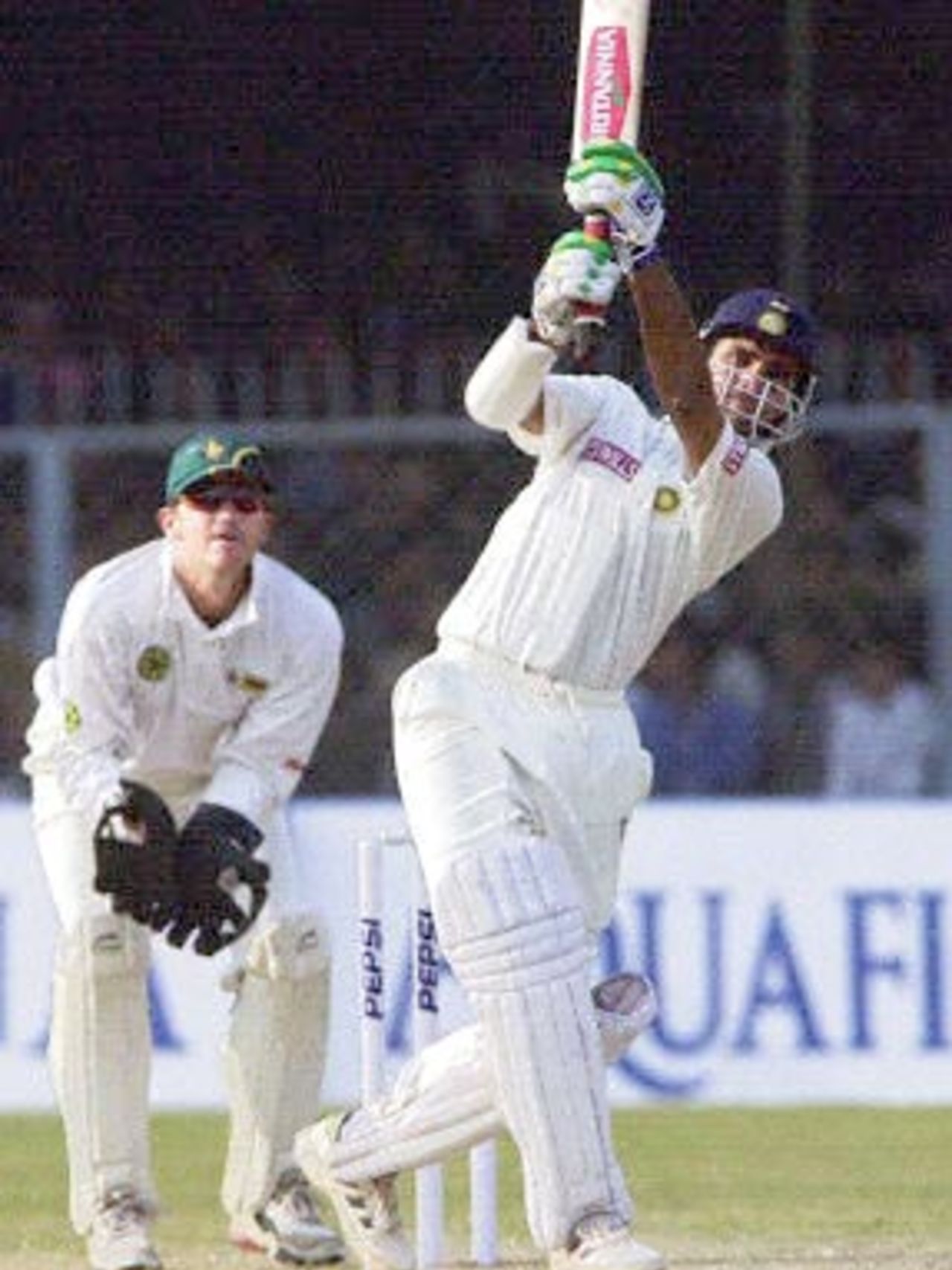 Indian skipper Sourav Ganguly hits a six off Zimbabwean spinner Bryan Murphy (not in picture) as Zimbabwe wicketkeeper Andy Flower looks on during the fourth one-day cricket match at Green Park in Kanpur, 11 December 2000. Ganguly claimed a career-best 5-35 and an unbeaten 71 off 68 balls as India beat Zimbabwe by nine wickets to win the one-day series. Ganguly was named man of the match.
