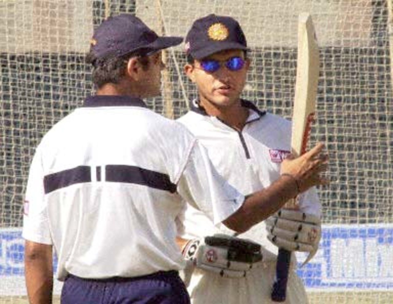 Suspended Indian cricket captain Sourav Ganguly (R) shows vice-captain Rahul Dravid (L) his bat in Rajkot, 13 December 2000. Dravid is taking over as captain of the Indian side for the final one-day international at the Municipal cricket ground at Rajkot. Ganguly has been suspended for one match as he breached the ICC code of conduct on three counts during play in Kanpur.