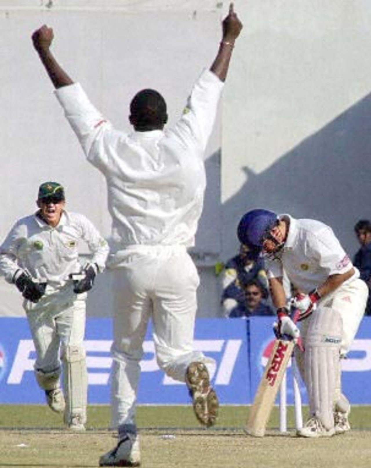 Indian star batsman Sachin Tendulkar (R) is clean bowled by a jubilant Mluleki Nkala (C) after he had Tendulkar