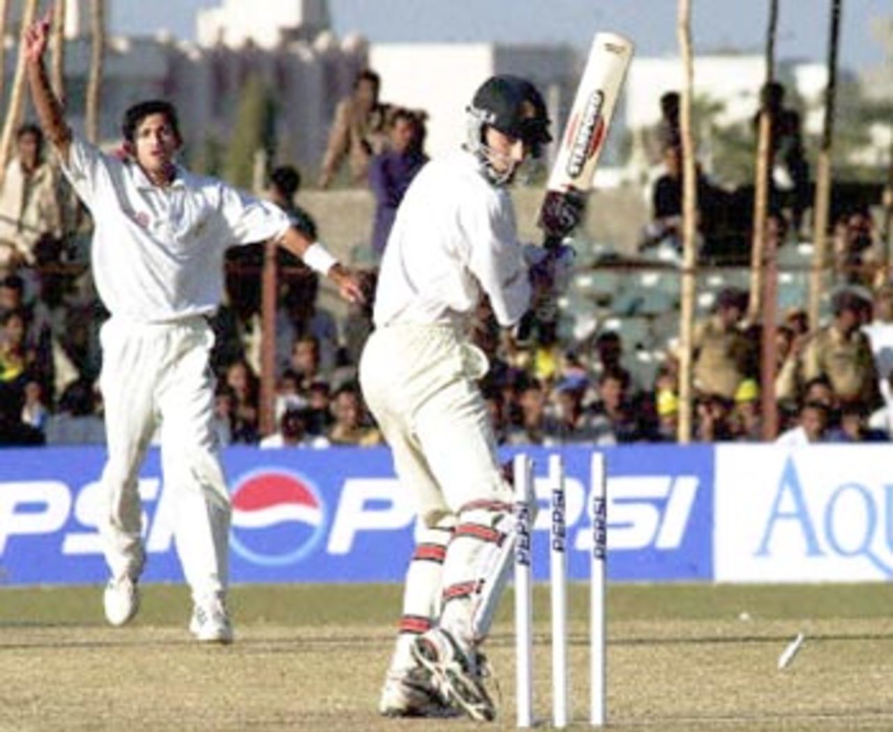 Indian bowler, Ajit Agarkar (L) jubilates after sending the bails flying off Zimbabwe batsman Brian Murphy's (R) stumps in the final match of the one-day international, 14 December 2000 at the Municipal cricket ground in Rajkot. Agarkar was declared 'Man of the Match' for having scored 67 runs off 25 balls that helped India win the match and the series.