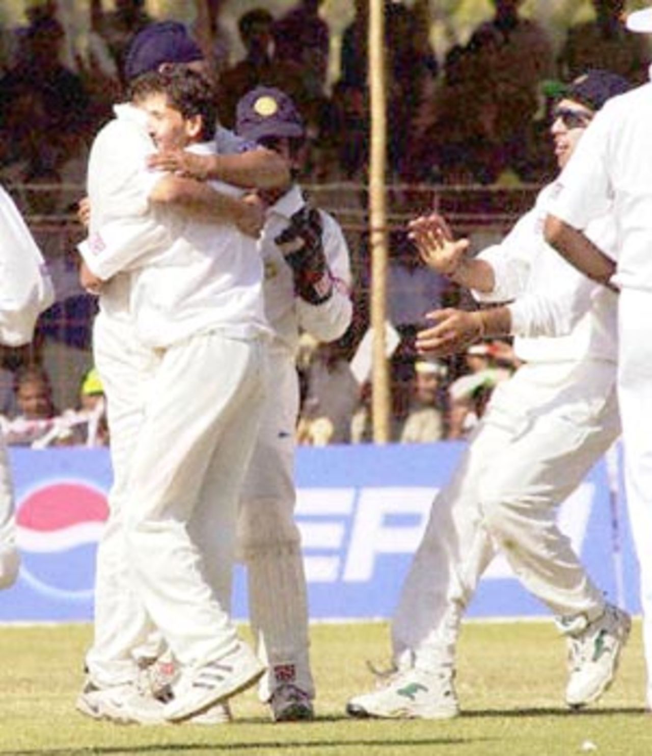 Ajit Agarkar (2nd L) is hugged by a teammate after the final match of the one-day international, 14 December 2000 at the Municipal cricket ground in Rajkot. Agarkar was declared the 'Man of the Match' for having scored 67 runs off 25 balls that helped India win the match and the series.