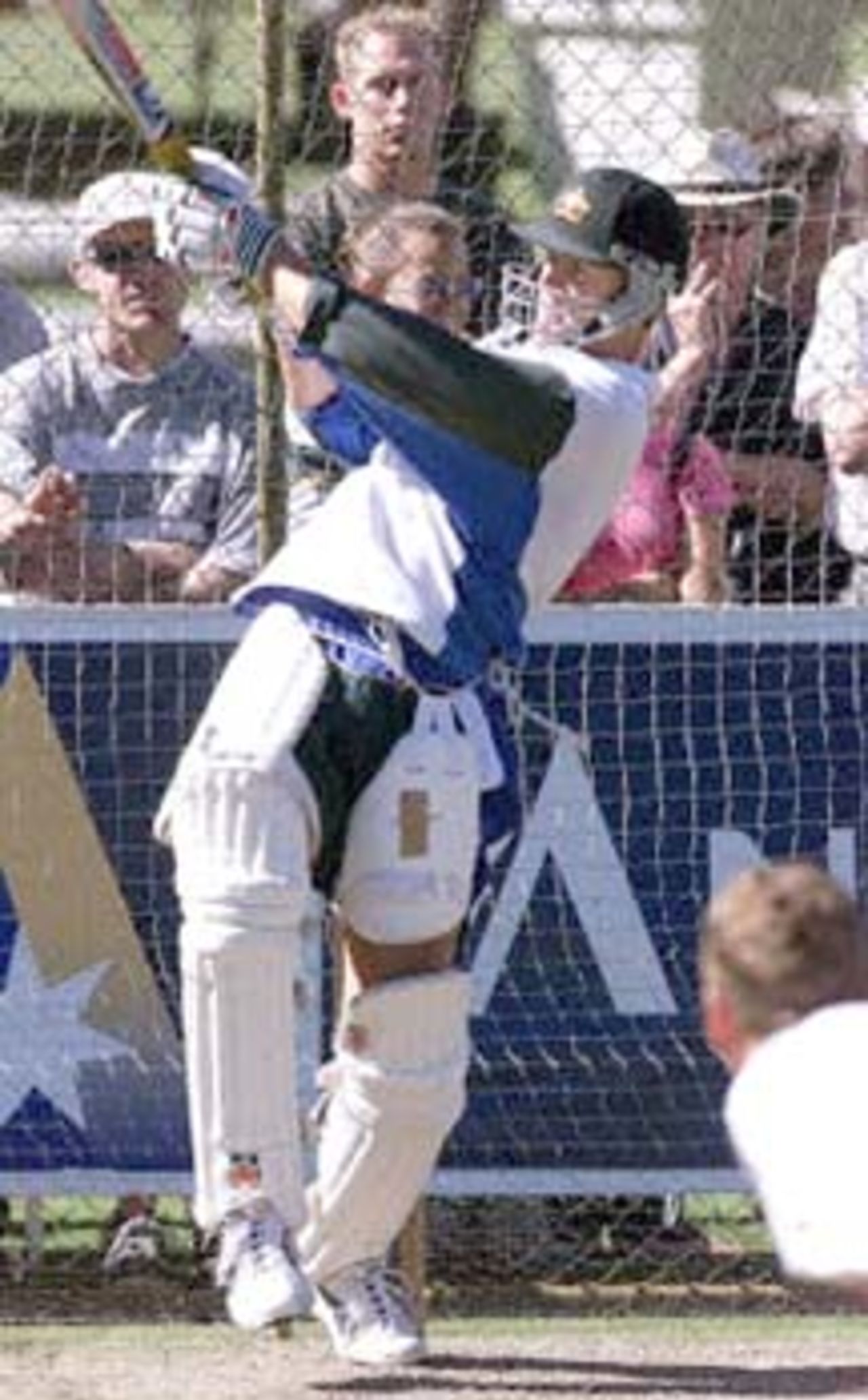 Australian wicketkeeper-batsman and stand in captain Adam Gilchrist, smashes the ball out of the practise nets area, during a training session at the Adelaide oval 14 December 2000. Gilchrist has replaced regular captain Steve Waugh, who has been forced to stand down from the third test being played in Adelaide from 15-19 December, due to injury. Australia currently leads the series against the West Indies 2-0.