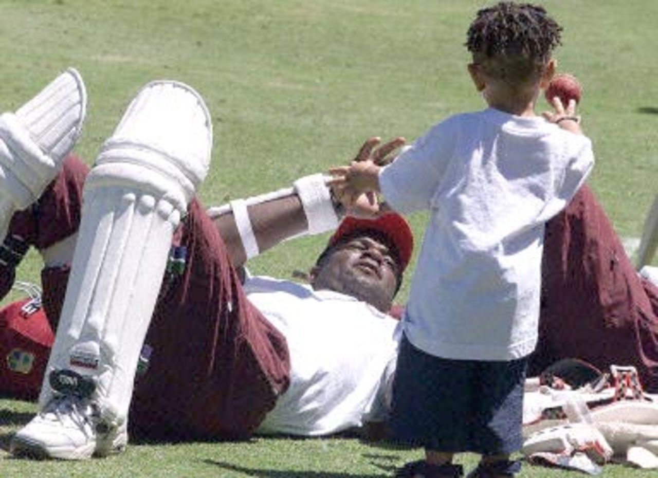 West Indies wicketkeeper-batsman Ridley Jacobs prepares to catch the ball thrown by Carl Hooper junior, son of the former test cricketer Carl Hooper, during a training session at the Adelaide oval 14 December 2000. Australia leads the series against the west Indies 2-0, with the third test being played in Adelaide from 15-19 December.