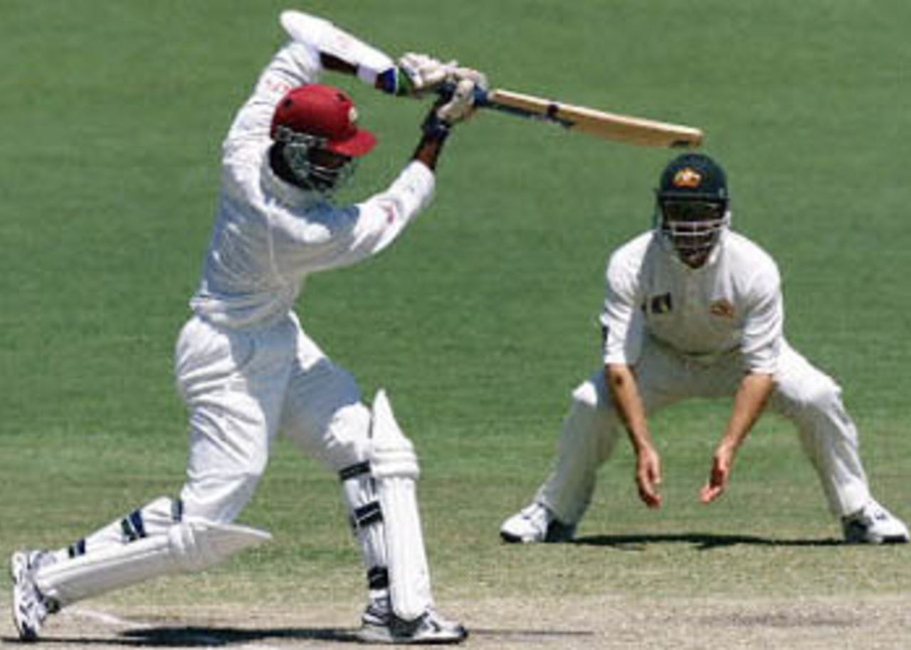 West Indies batsman Daren Ganga (L) drives the ball for four runs on day four of the third Test match at the Adelaide Oval 18 December 2000. Australia survived some anxious moments to ease themselves into a winning position against the West Indies, as the home team went to stumps with 98 for four, needing just another 32 runs, to be well poised to extend to 13 their world record sequence of Test victories. Player at R is unidentified.