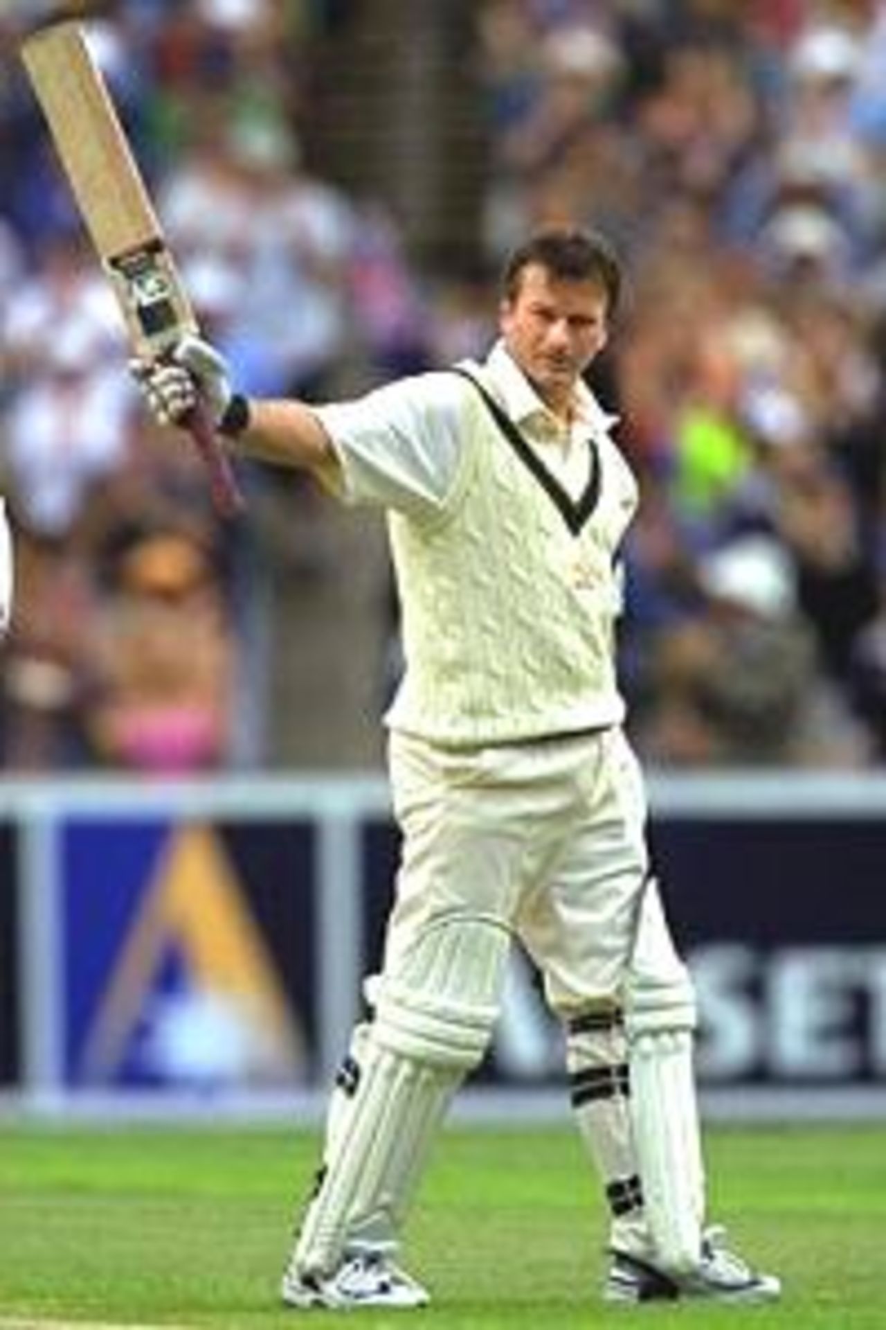 27 Dec 2000: Steve Waugh of Australia raises his bat after making 100 runs,in the 4th test match between Australia and the West Indies, played at the Melbourne Cricket Ground in Melbourne, Australia.