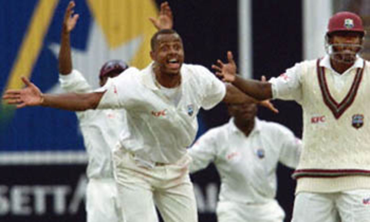 West Indian paceman Courtney Walsh (2/L) reacts in disbelief as the umpire refuses to give a dismissal in his favour as teammate Wavell Hinds looks on on the first day of the fourth Test Match at the MCG in Melbourne, 26 December 2000. Australia finished the day at 295-7 with captain Steve Waugh not out on 98.