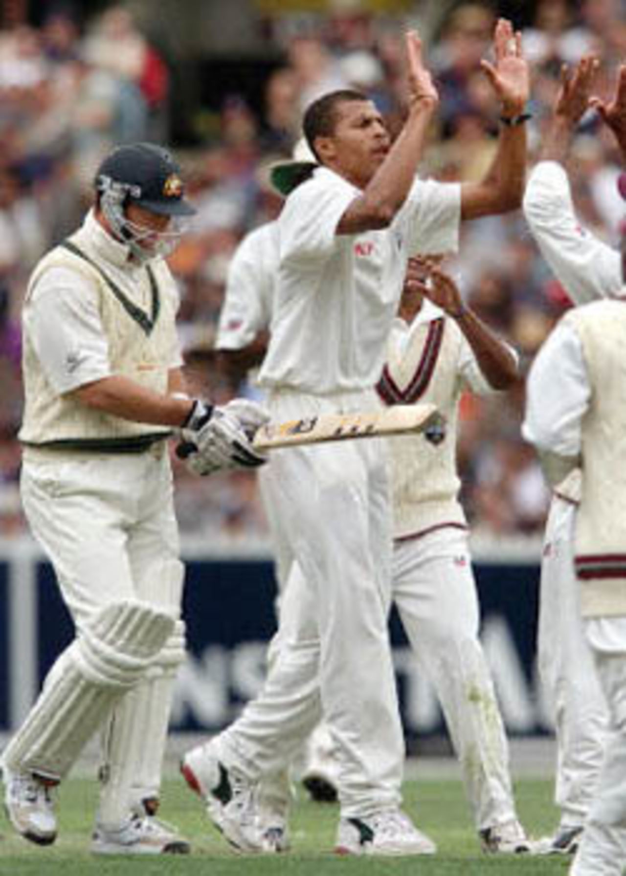 West Indian paceman Mervyn Dillon (C) celebrates with his teammates after dismissing Australian batsman Mark Waugh (L) on the first day of the fourth Test Match at the MCG in Melbourne, 26 December 2000. Australia finished the day at 295-7 with captain Steve Waugh not out on 98.