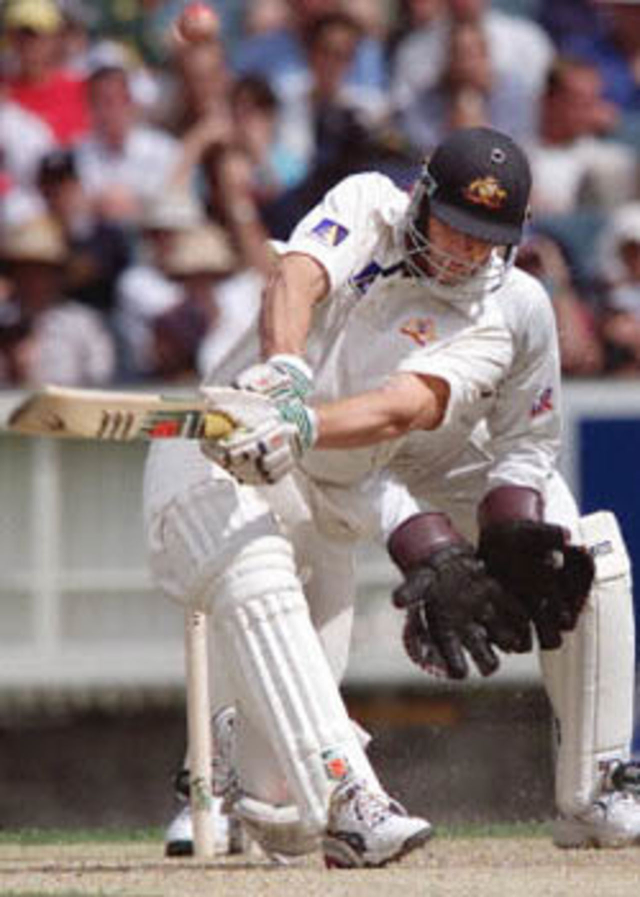 Australian batsman Adam Gilchrist hits a ball from West Indian spinner Marlon Samuels hard and high on the first day of the fourth Test Match at the MCG in Melbourne, 26 December 2000. Australia finished the day at 295-7 with captain Steve Waugh not out on 98.