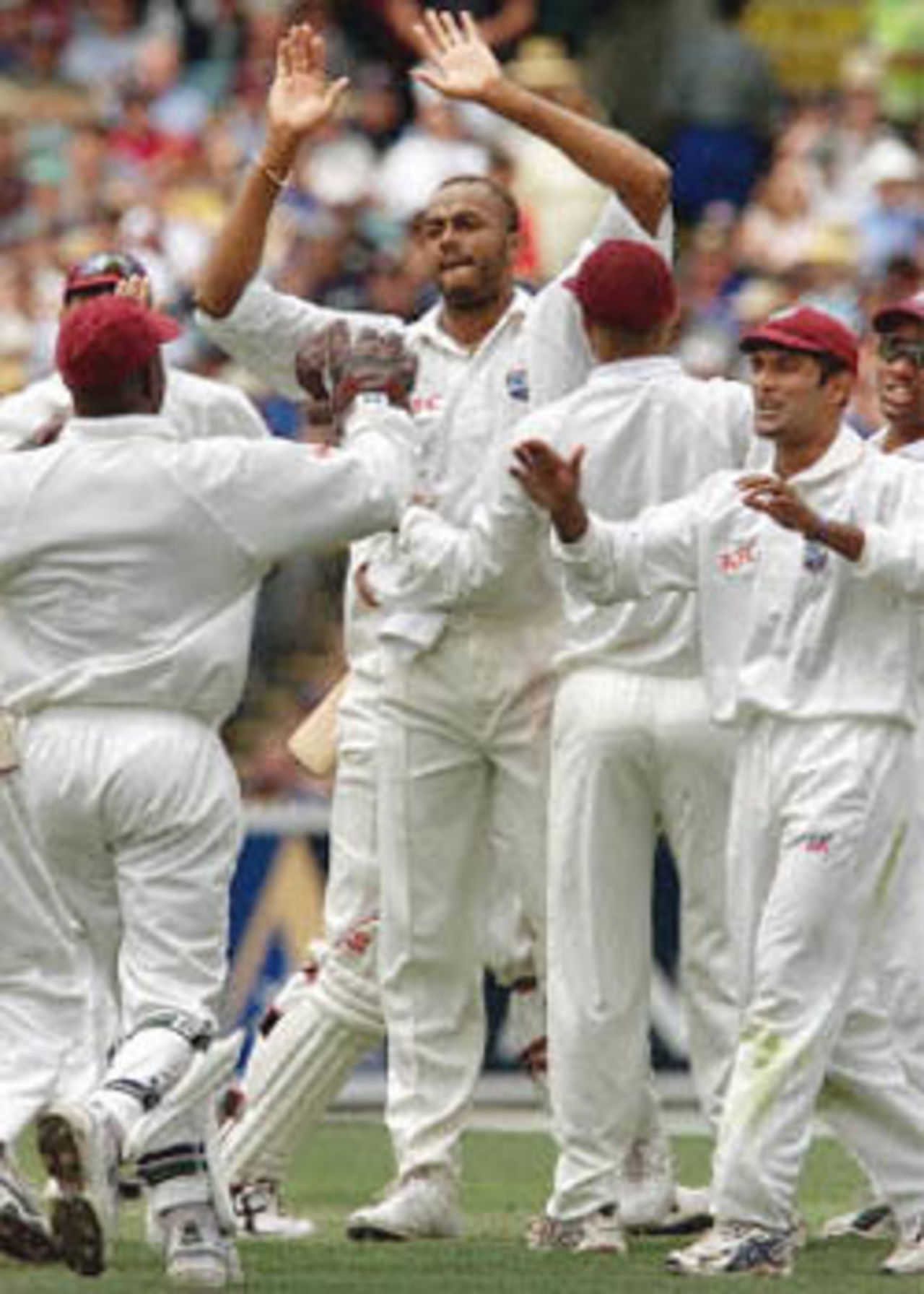 West Indian fast bowler Courtney Walsh (C) celebrates with his teammates after taking the wicket of Australian batsman Matthew Hayden caught behind for 13 on the first day of the fourth Test Match at the MCG in Melbourne 26 December 2000. At lunch Australia is 77-2 with Mark Waugh and Justin Langer the two not out batsmen.