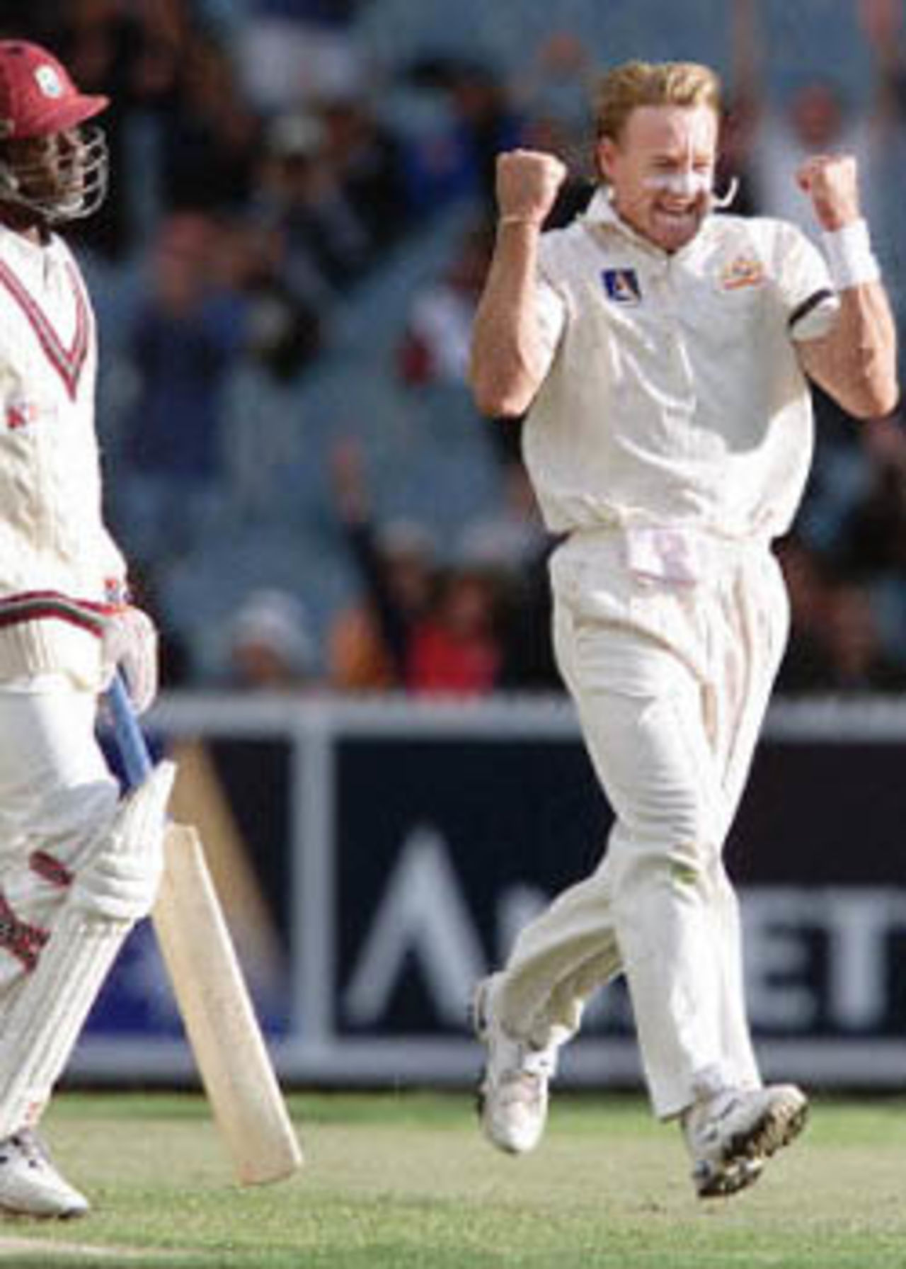 Australian fast bowler Andrew Bichel (R) celebrates after bowling West Indian batsman Colin Stuart (L) as the West Indies just manage to avoid the follow on on the second day of the fourth Test Match at the MCG in Melbourne, 27 December 2000. The West Indies scored 165 runs in their first innings in reply to Australia's total of 364 runs with Australia to start their second innings tomorrow December 28.