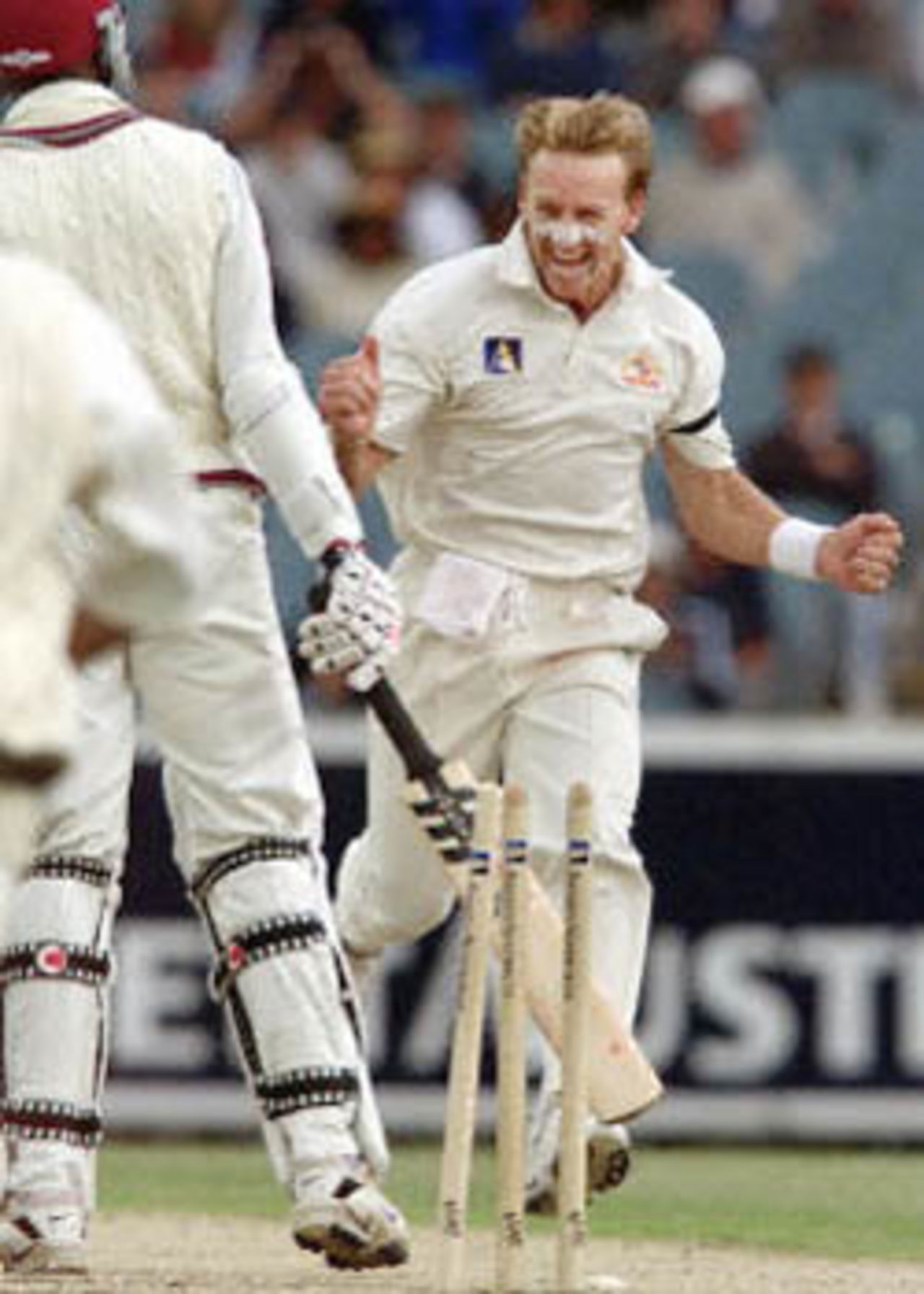Australian fast bowler Andrew Bichel (R) celebrates after bowling West Indian batsman Nixon McLean (L) as the West Indies just manage to avoid the follow on on the second day of the fourth Test Match at the MCG in Melbourne 27 December 2000. The West Indies scored 165 runs in their first innings in reply to Australia's total of 364 runs with Australia to start their second innings tomorrow December 28.
