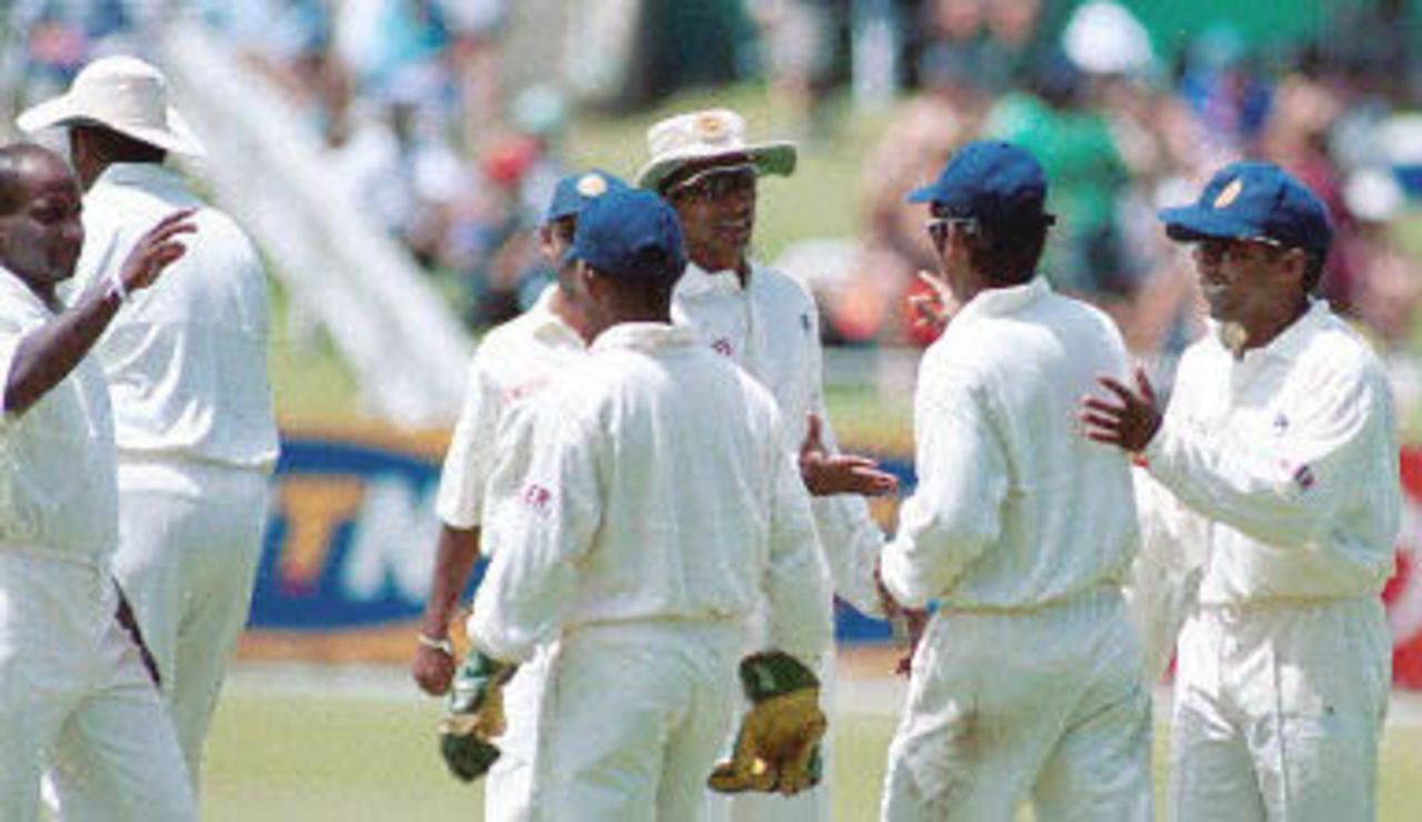 Sri Lankan fielder Kumar Sangakarra is congratulated by his team mates at taking the catch of South African batsman Lance Klusener at Durban's Kingsmead cricket stadium on 27 December 2000 during the second day of the first test match.