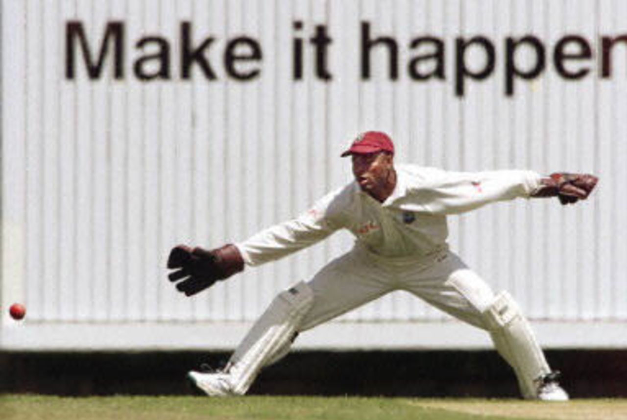 West Indian wicketkeeper Ridley Jacobs attempts to stop a ball in front of an appropriate advertising banner as the West Indies continues to struggle on the third day of the fourth Test match at the MCG in Melbourne, 28 December 2000. Australia in their second innings is 165-3 at tea for a daunting 364 run lead.